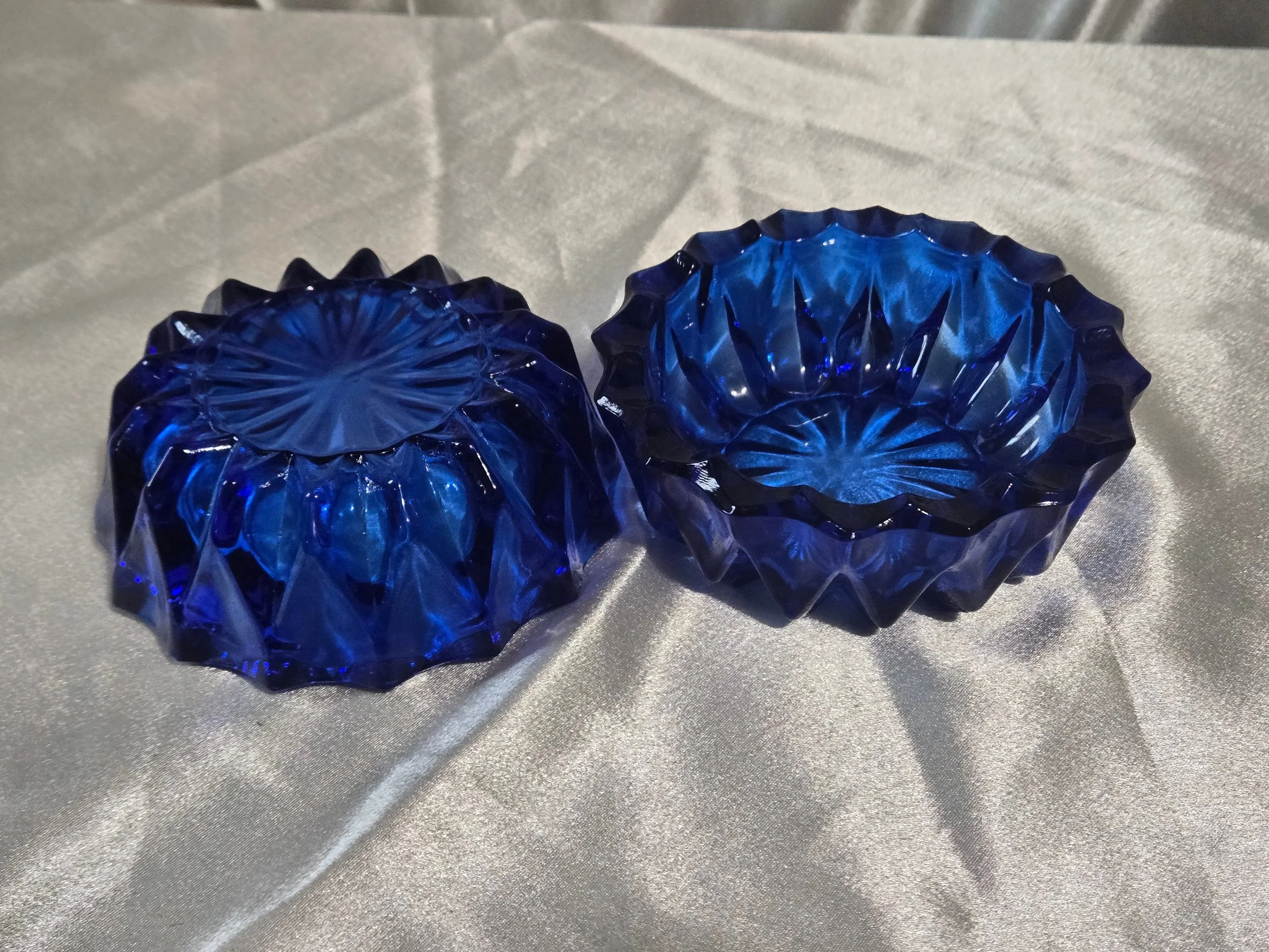 Pair of cobalt blue glass bowls one face down and one face up
