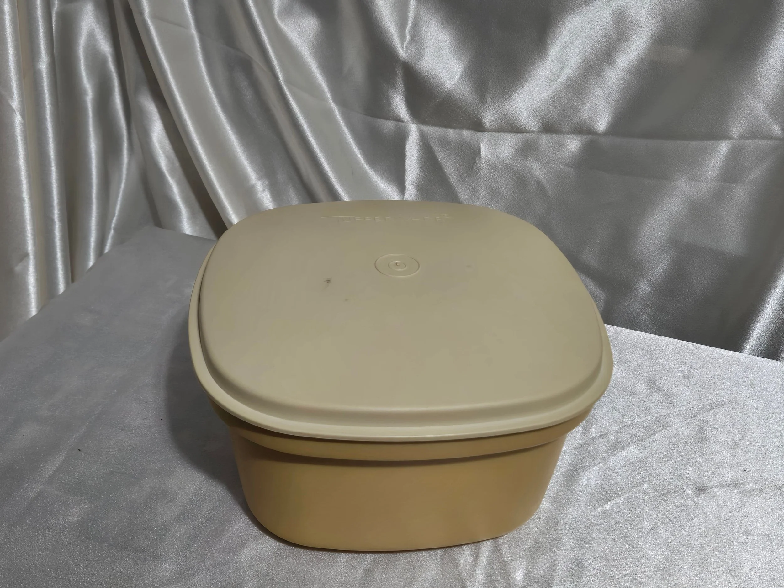 Vintage Tupperware microwave steamer in mustard yellow and ivory with lid, vented insert, and base shown together.