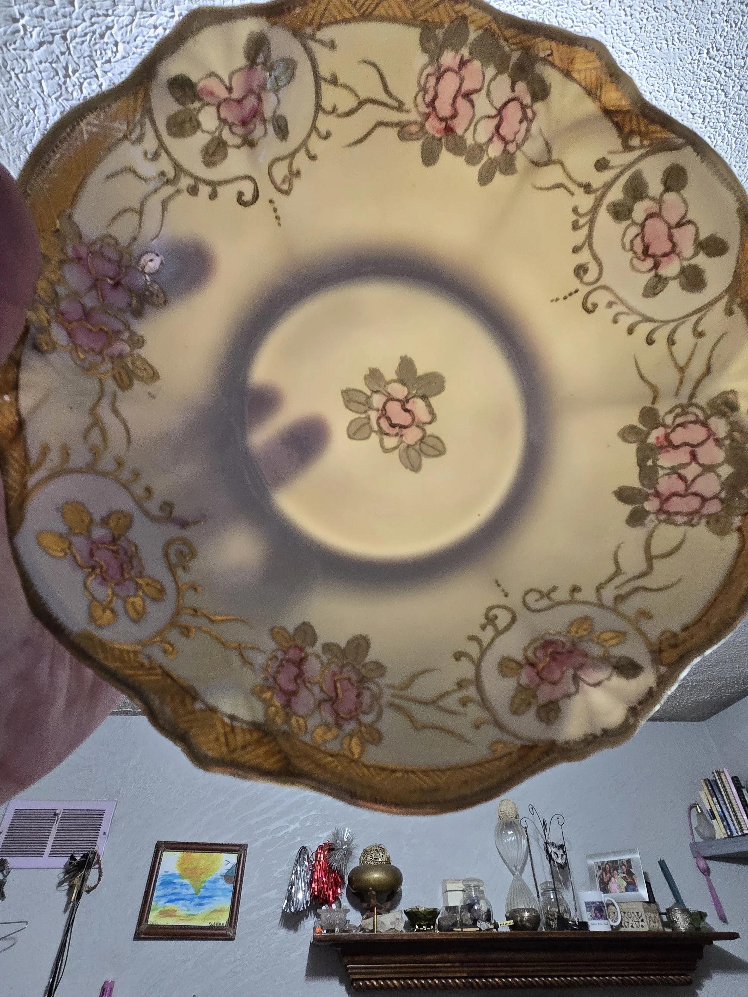 Translucent antique Nippon eggshell porcelain bowl held to the light