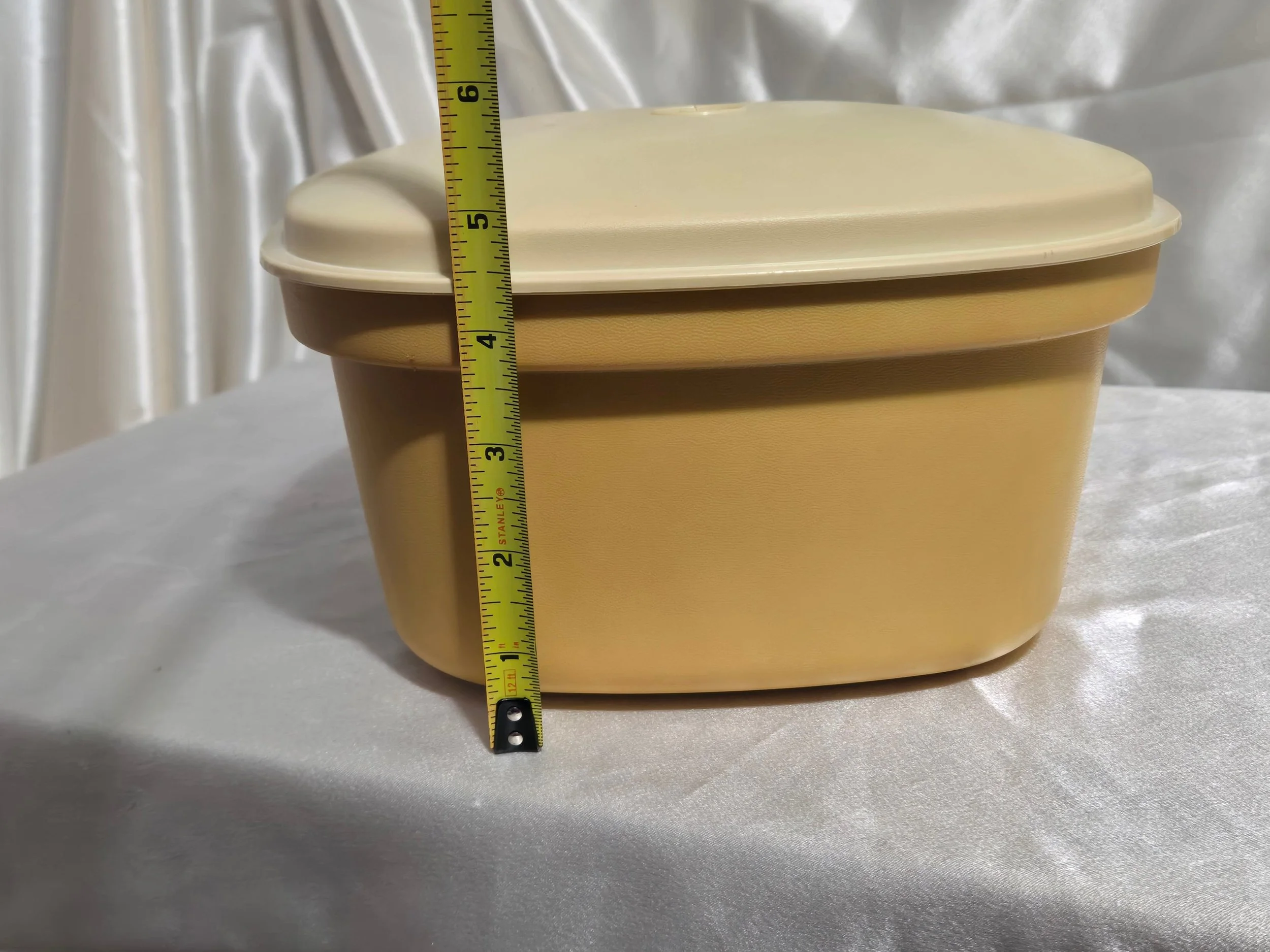 Vintage Tupperware microwave steamer in mustard yellow and ivory with base showing height measurement