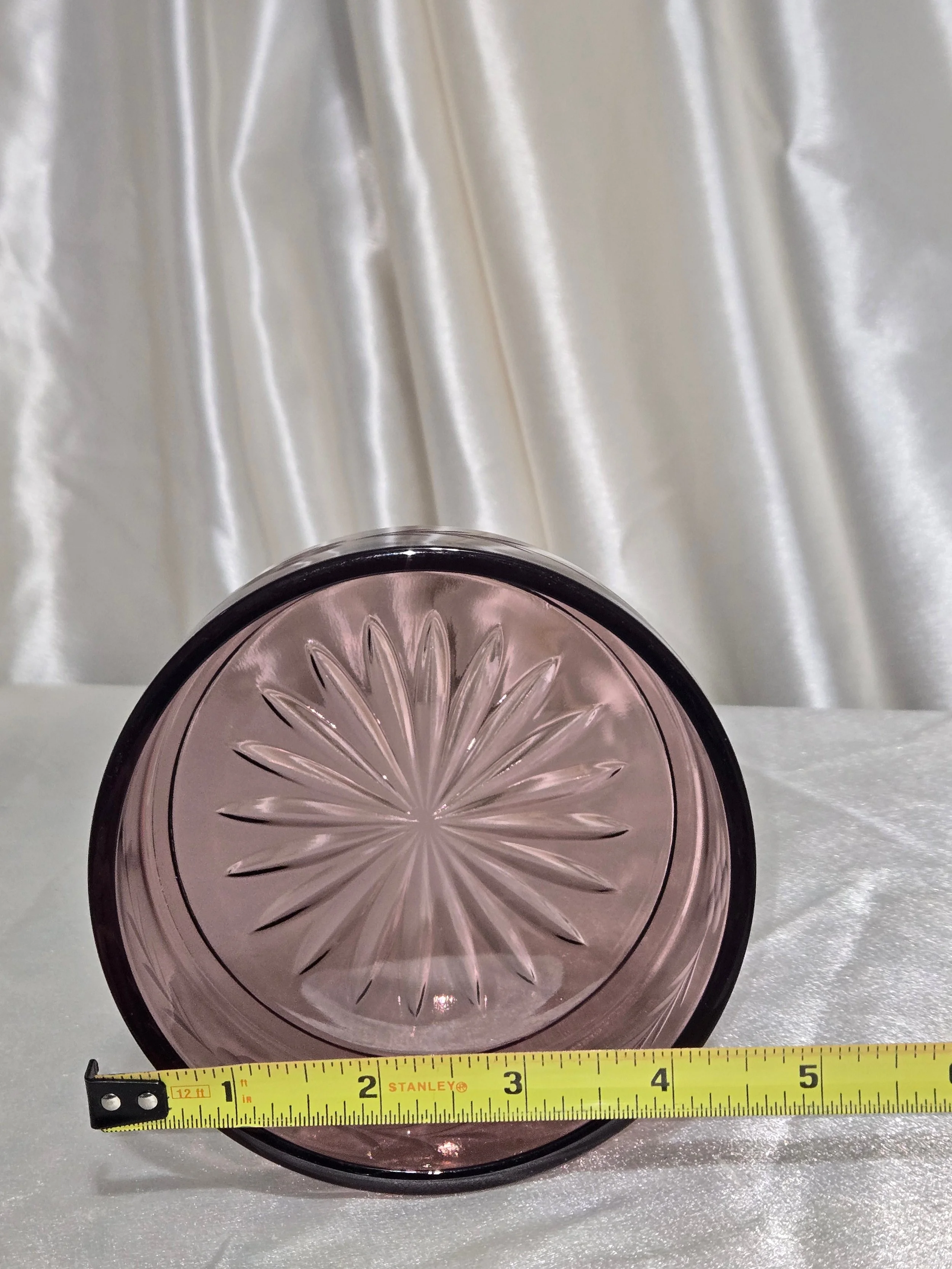 Close-up of pressed floral pattern in purple glass