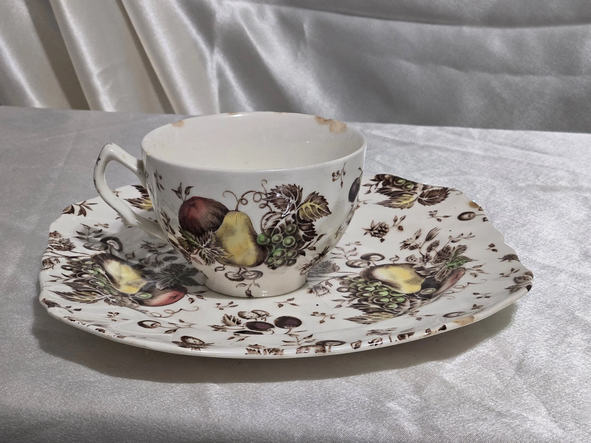 Vintage Autumn’s Delight floral dish with warm orange and gold tones, embossed leaf pattern, and scalloped edges on display.