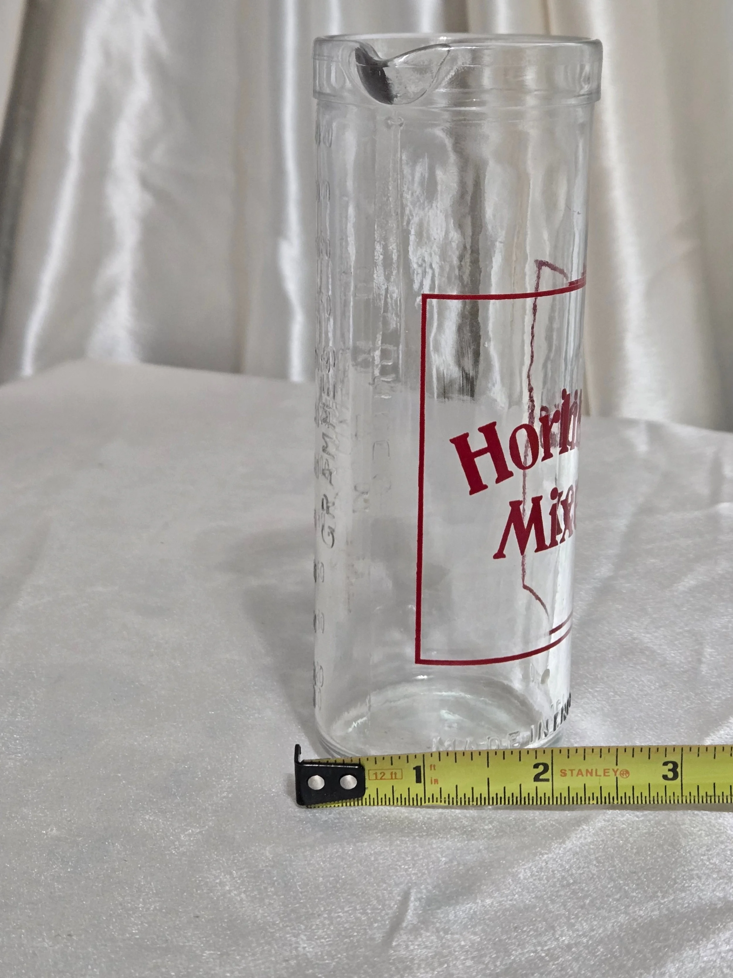 Close-up of vintage Horlicks Mixer lettering and glass surface