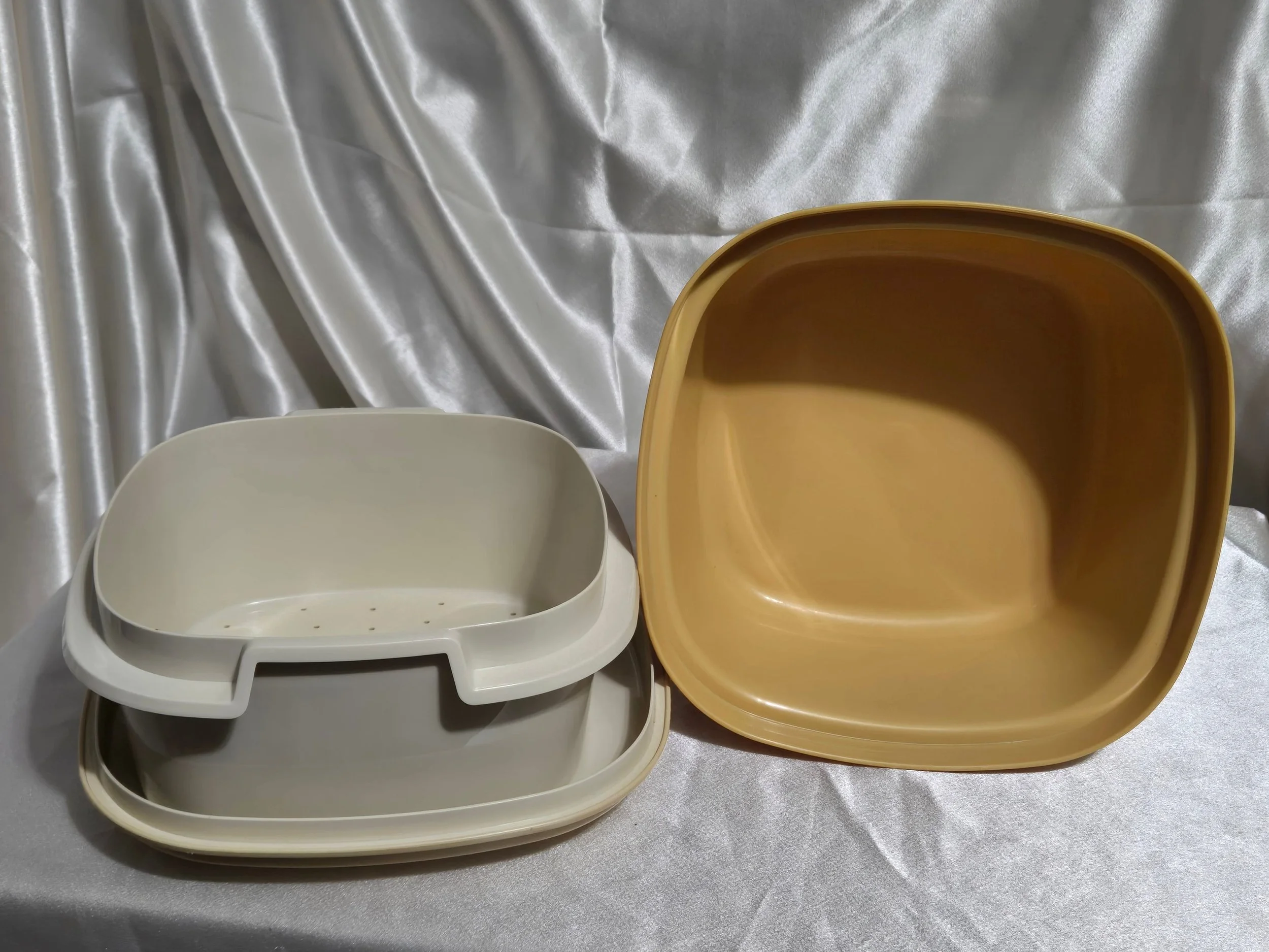 Vintage Tupperware microwave steamer in mustard yellow and ivory with vented insert out of base and showing inside of base bowl