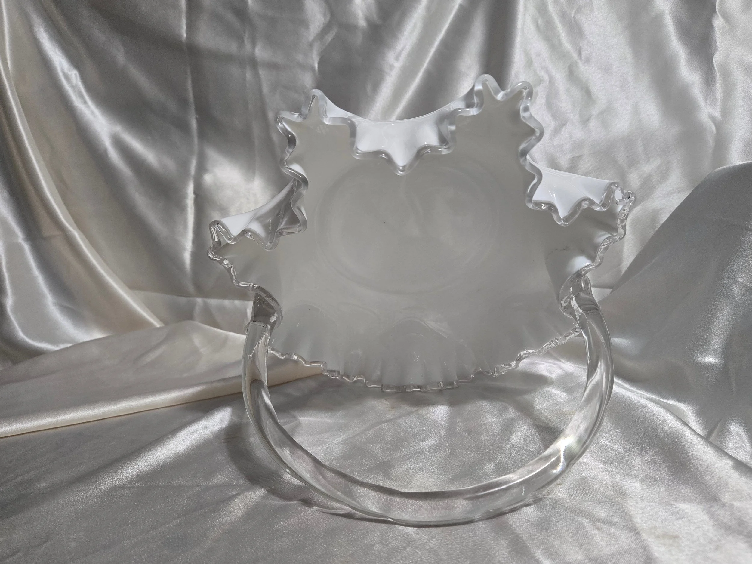 Vintage Fenton-style clear glass bowl featuring etched floral pattern and crown motif with visible handle repair.