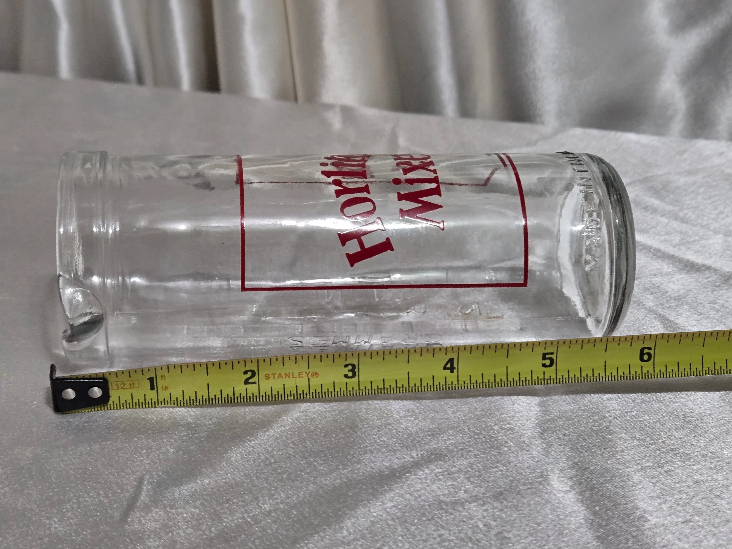 Horlicks Mixer glass laid horizontally with measurement tape