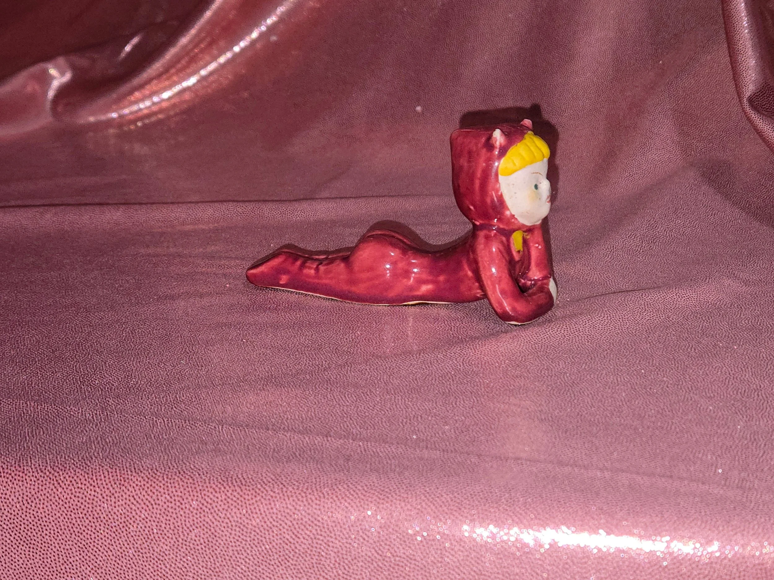 Side view of vintage devil figurines