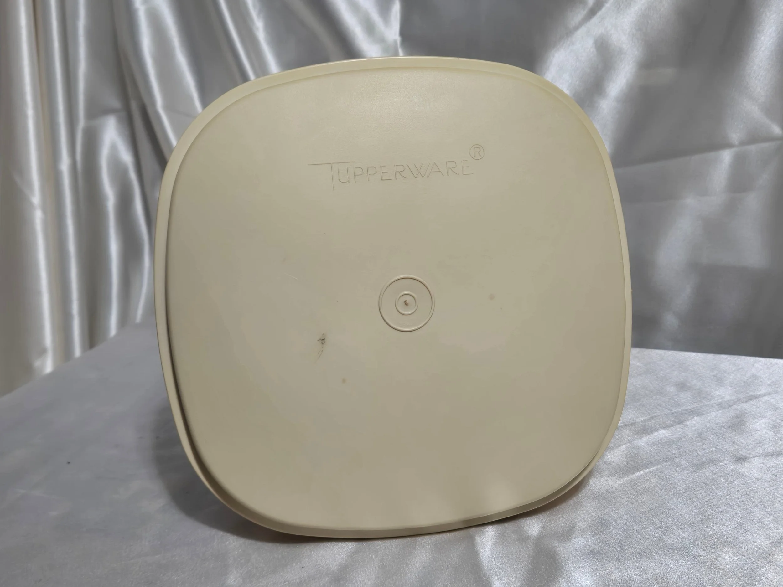 Vintage Tupperware microwave steamer in mustard yellow and ivory with the top of lid view on its side