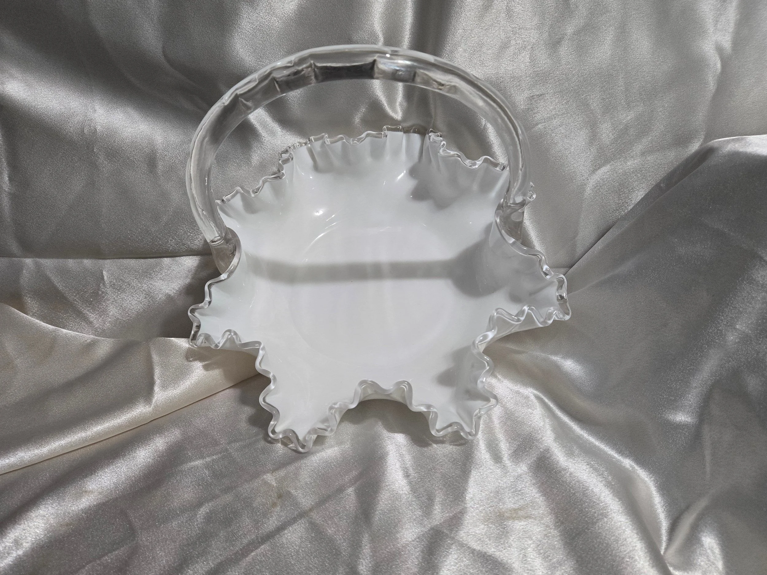 Vintage Fenton-style clear glass bowl featuring etched floral pattern and crown motif with visible handle repair.