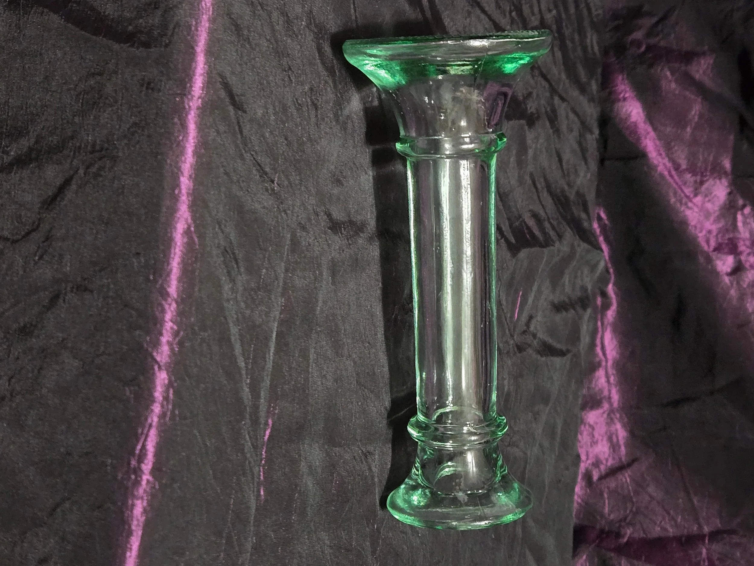 Clear glass candlestick holder with faint green tint, elegant fluted base, and timeless vintage style.