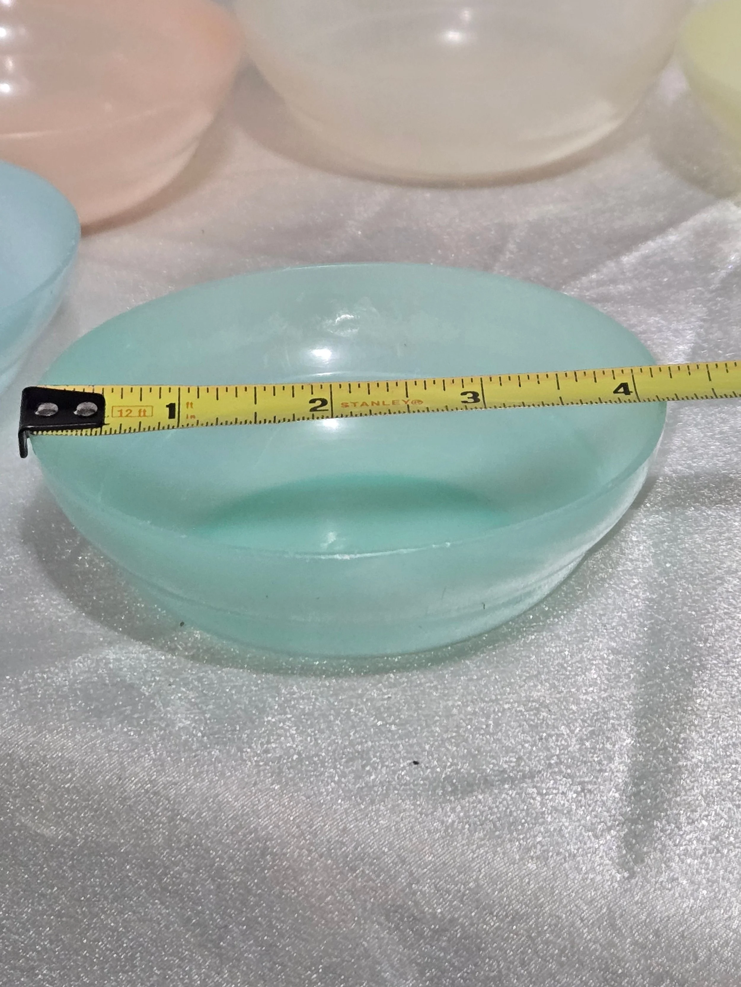Close-up of translucent pastel Tupperware bowl
