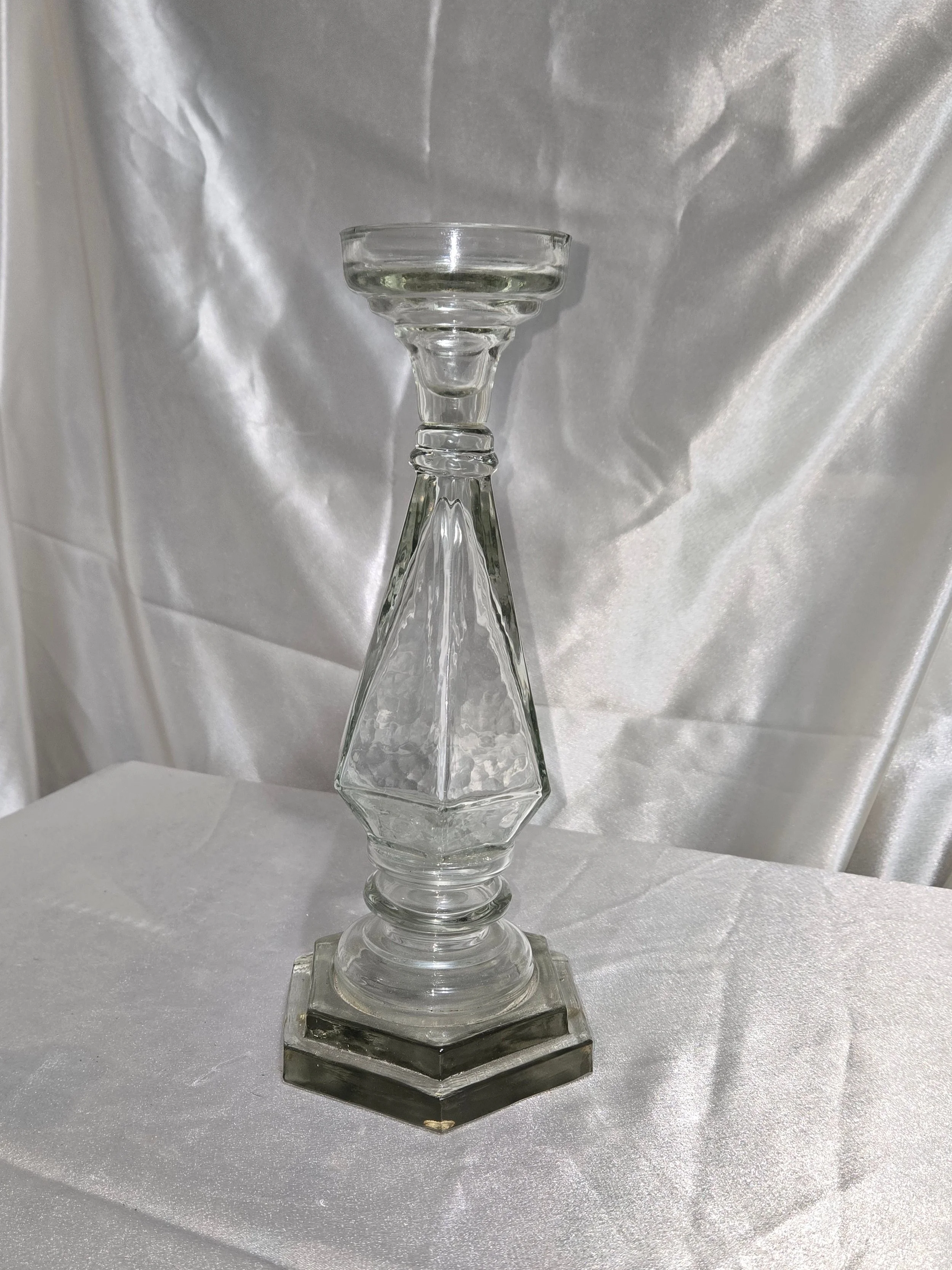 Vintage clear glass candle holder standing upright