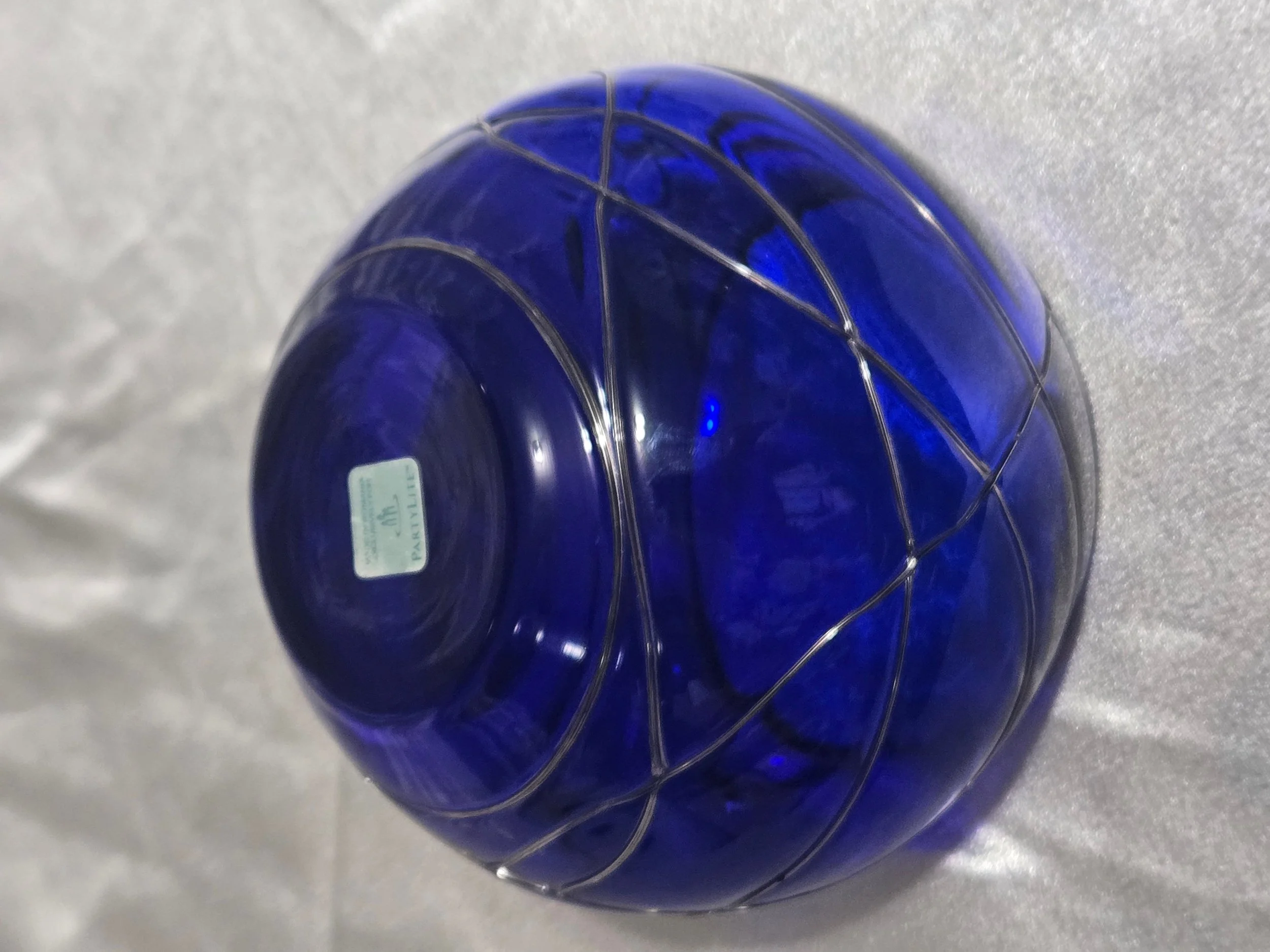 Cobalt blue hand-blown glass vase with silver swirl detailing, rounded art glass bowl, Murano-style decorative piece.