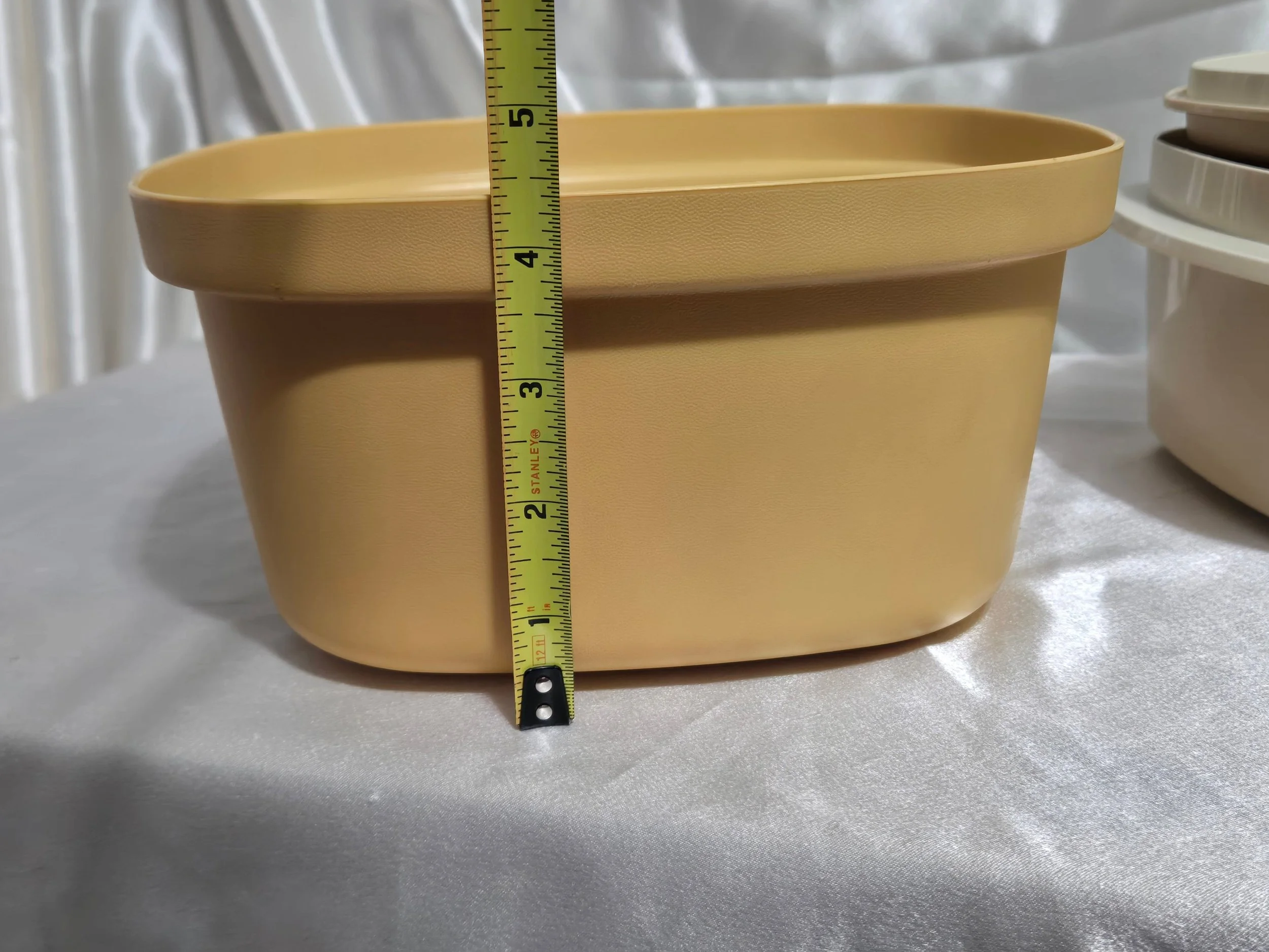 Vintage Tupperware microwave steamer in mustard yellow and ivory with base showing height measurement