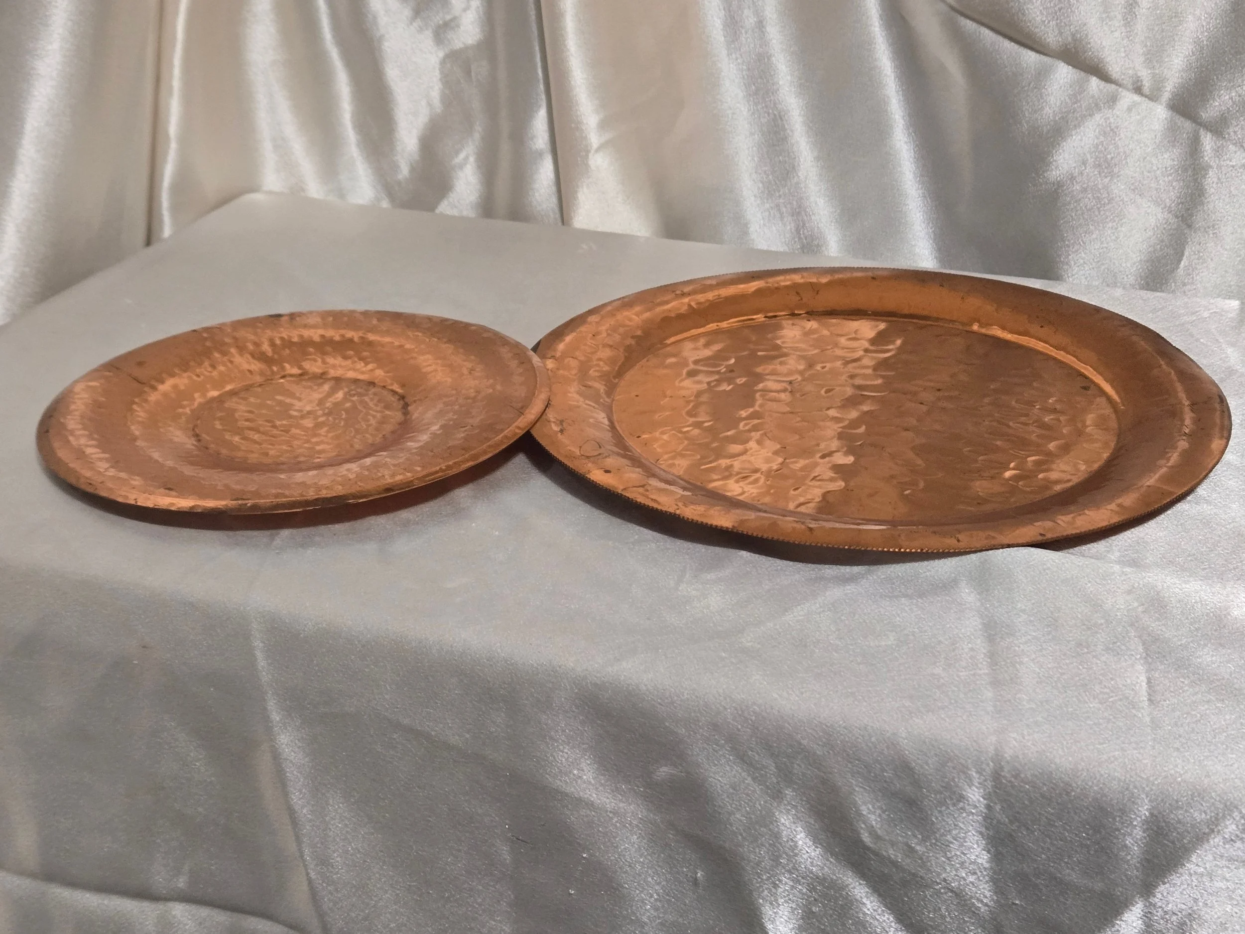 2 hammered copper trays one large and a smaller one