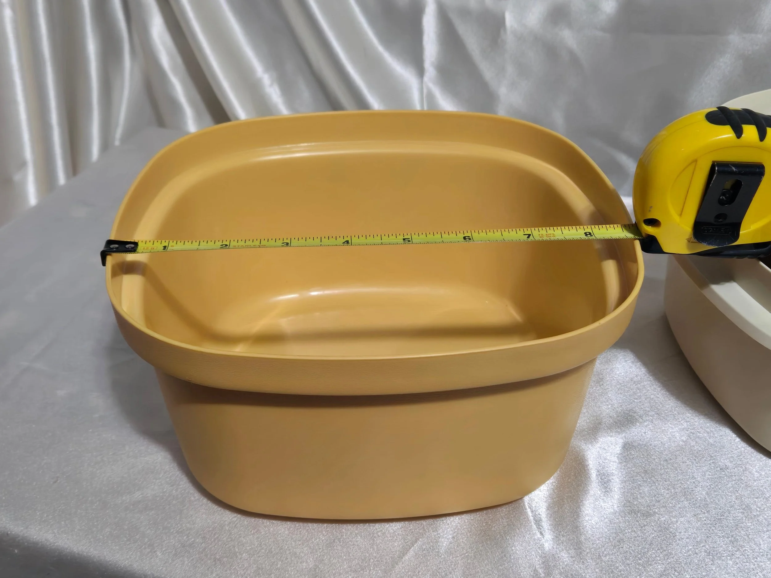 Vintage Tupperware microwave steamer in mustard yellow and ivory with base showing width measurement