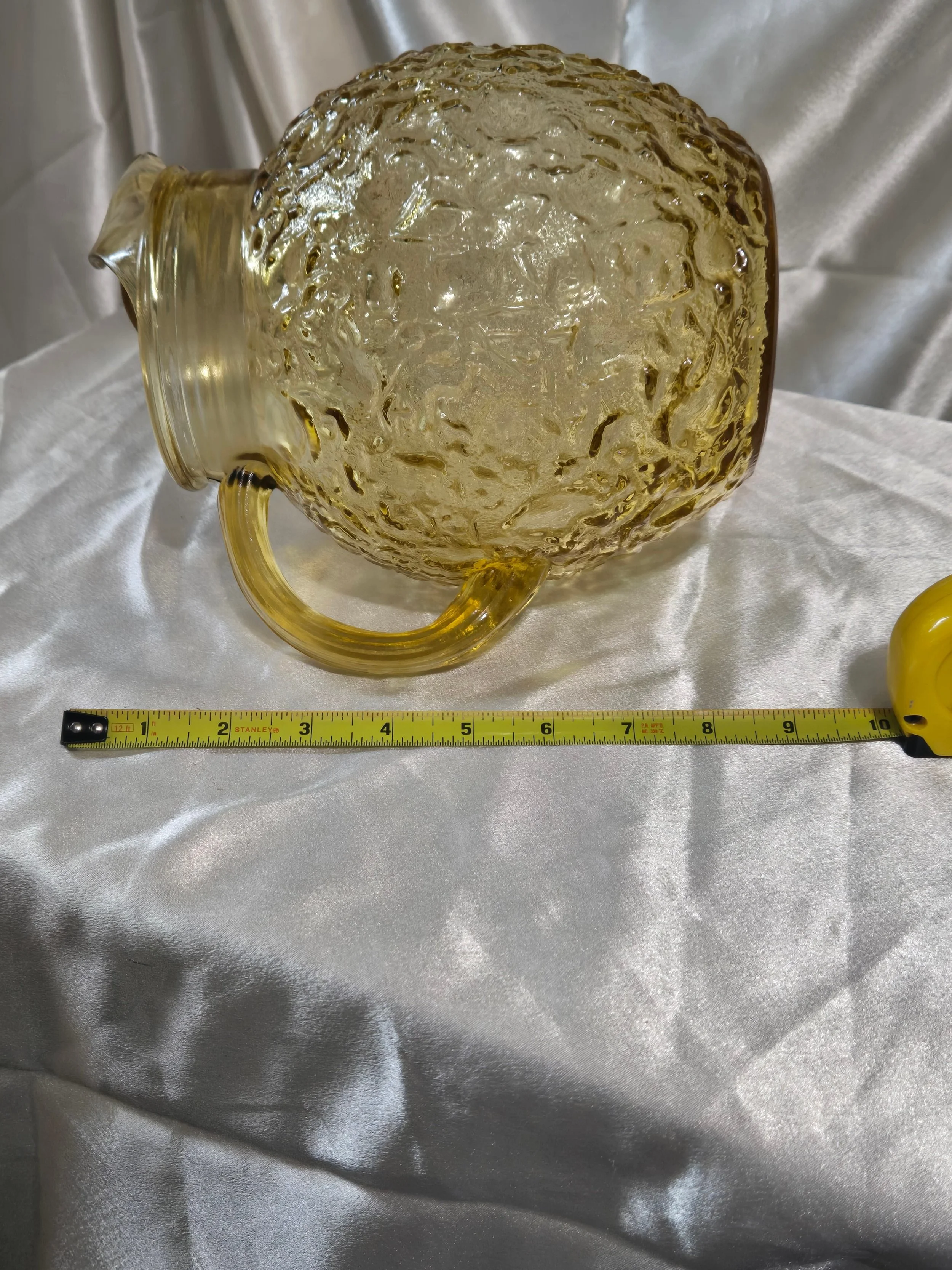 Bottom view of vintage amber glass pitcher showing width