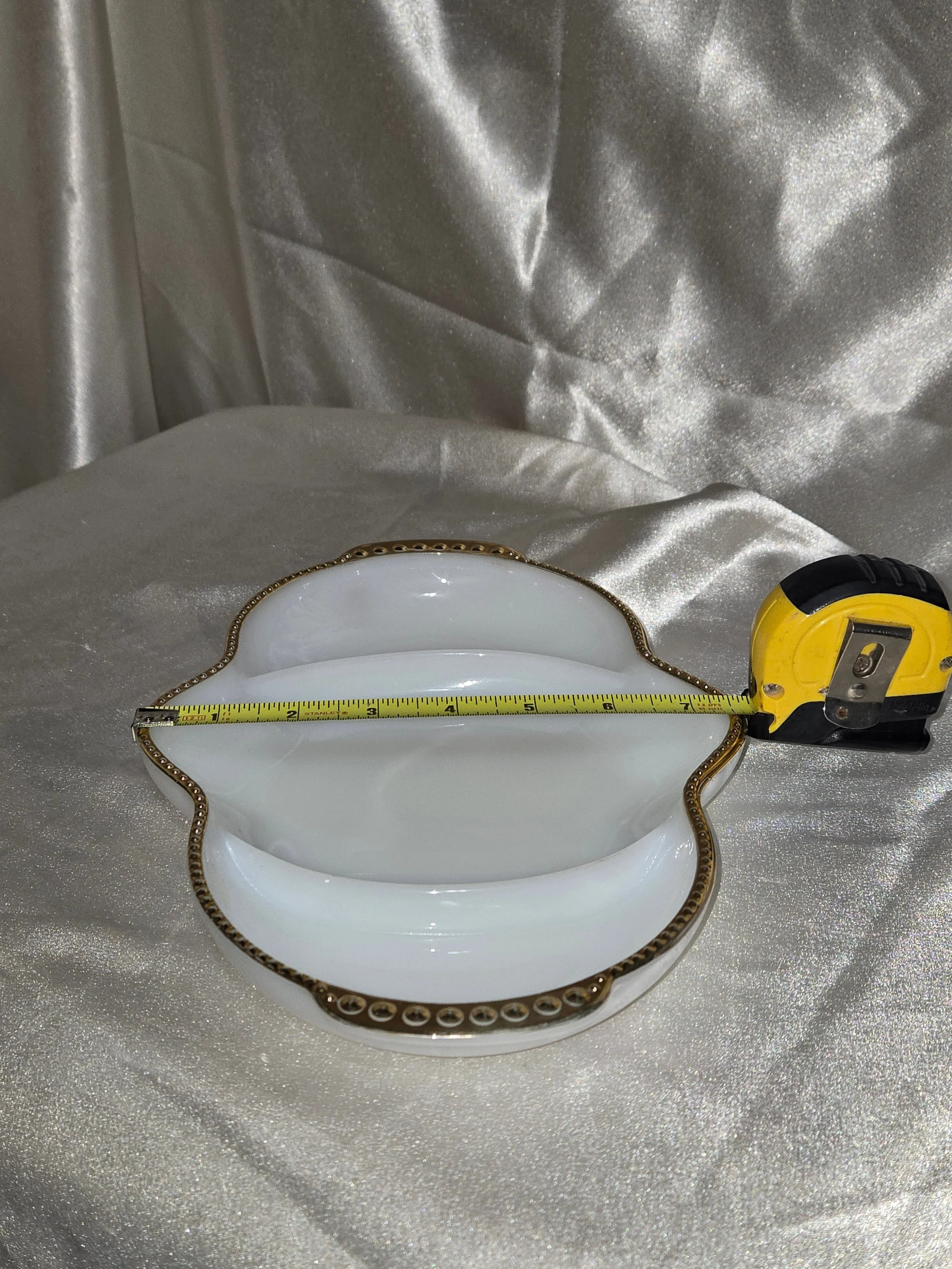 White Fire King relish tray with gold trim with measurement showing width