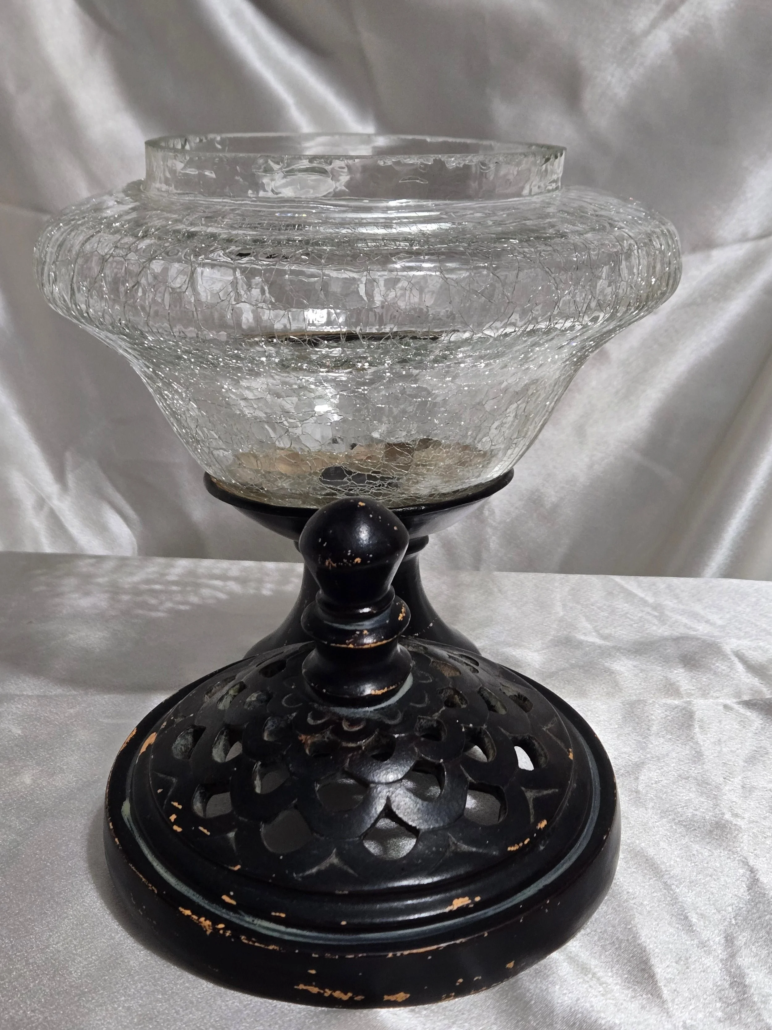 Vintage crackle glass apothecary jar with black metal lid and pedestal base, clear textured glass with distressed finish.