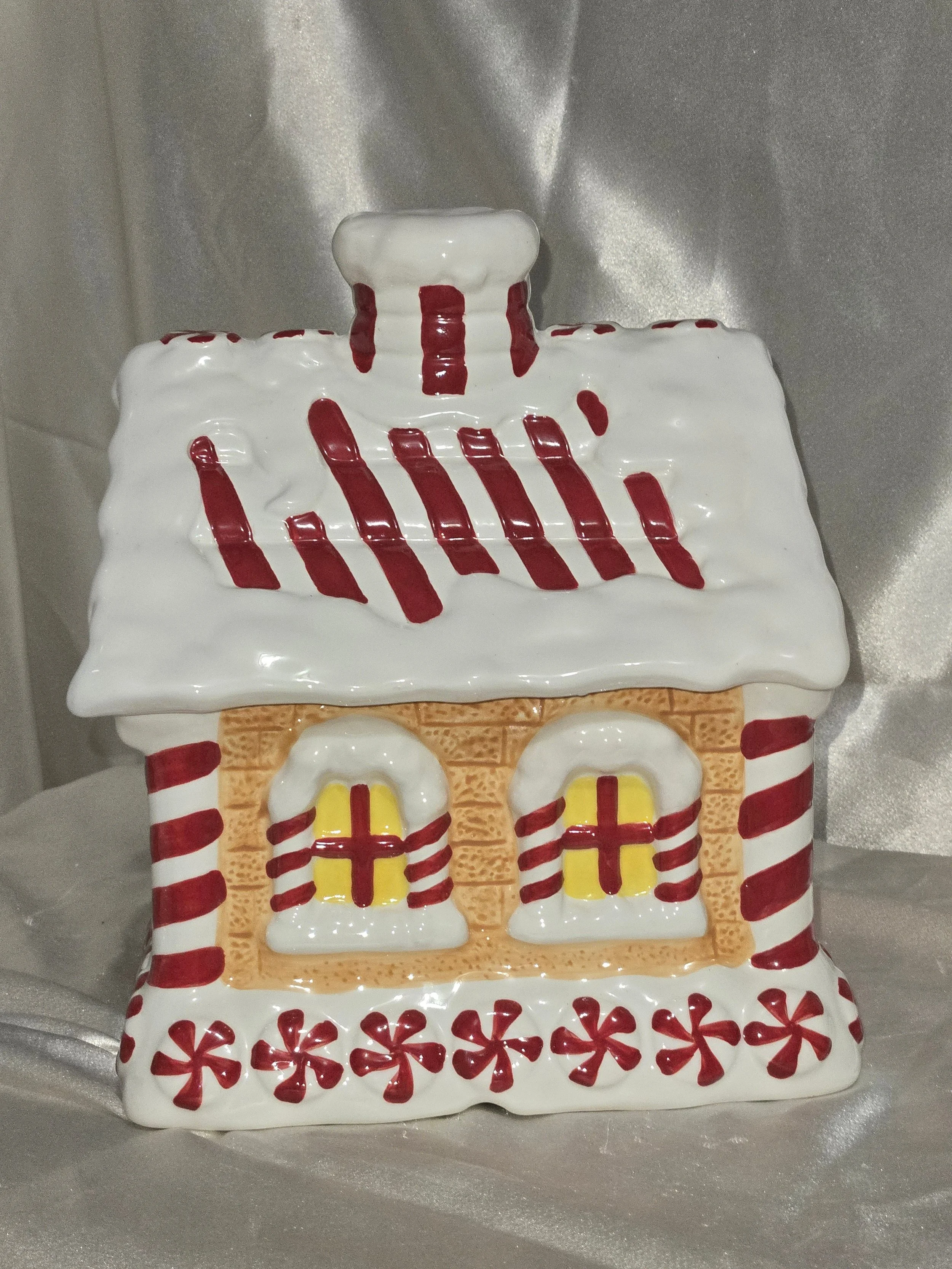 Vintage ceramic gingerbread house cookie jar by Le Gourmet Chef with snowy icing details and candy accents.