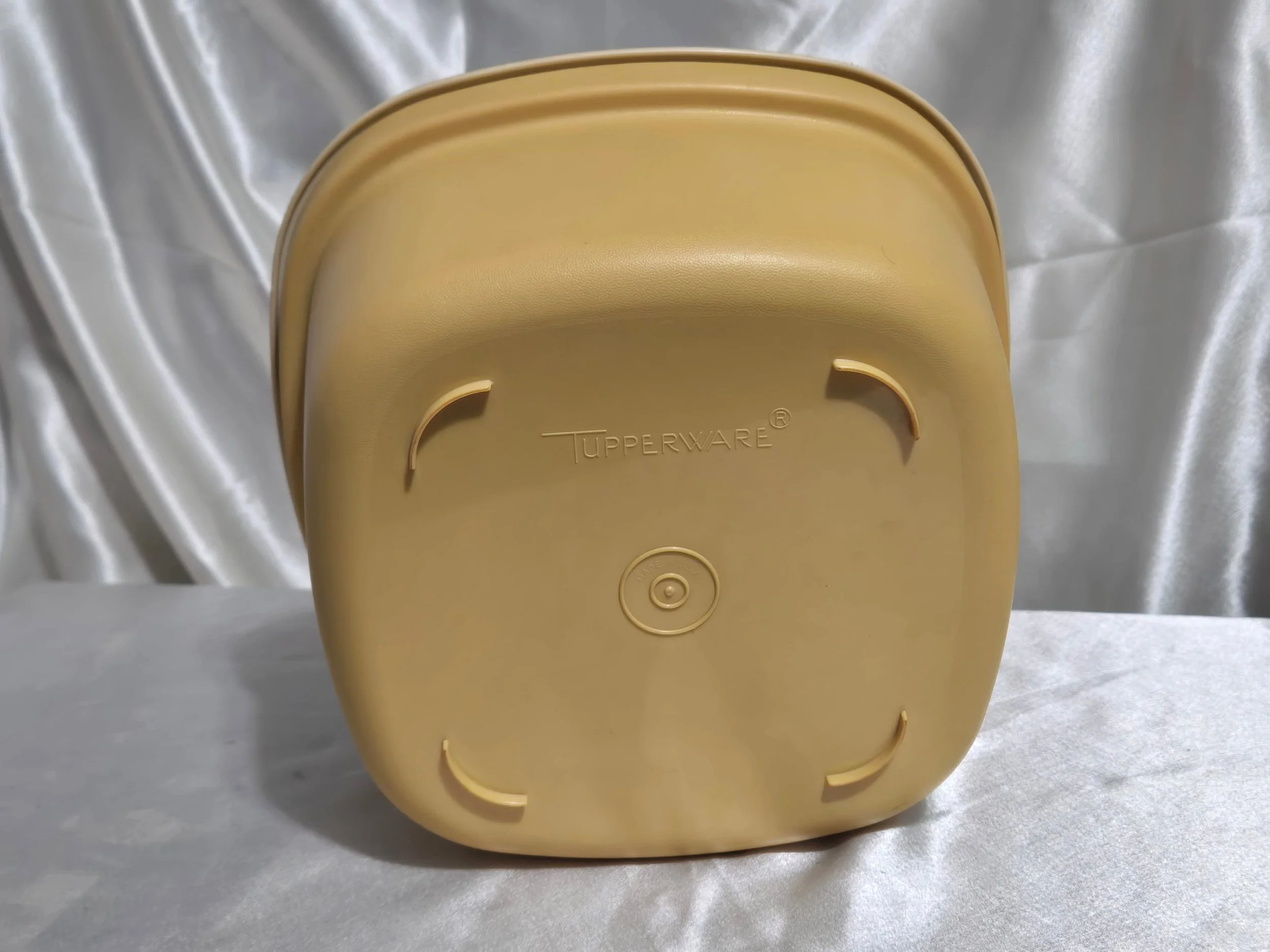 Vintage Tupperware microwave steamer in mustard yellow and ivory with bottom of base view shown together.