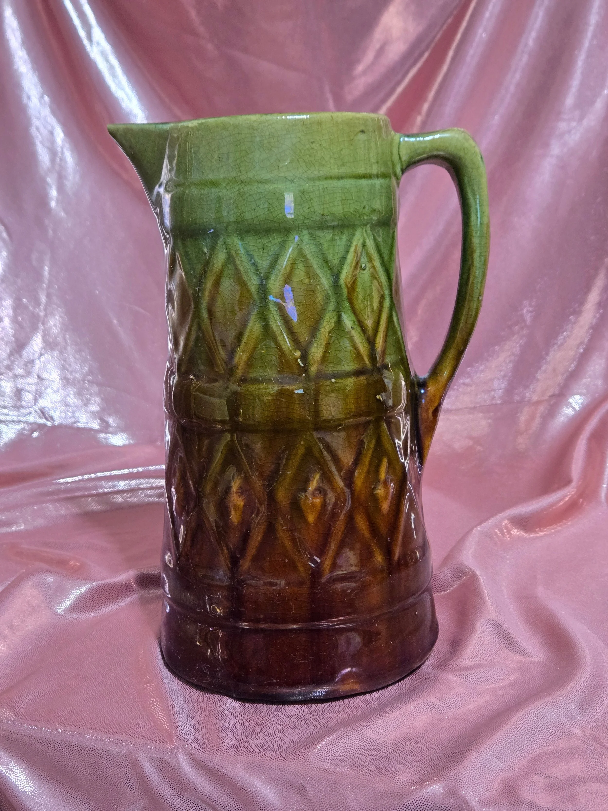 Tall ceramic pitcher with handle and spout