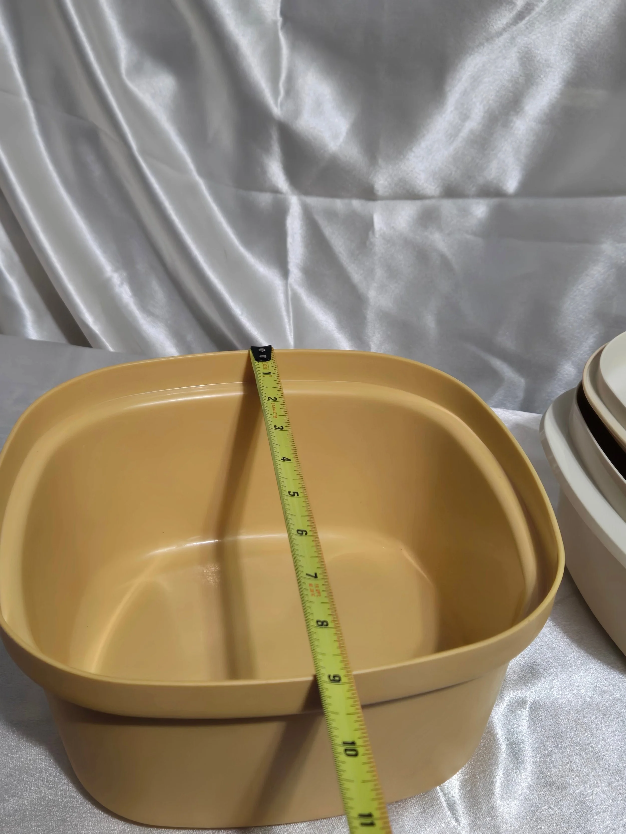 Vintage Tupperware microwave steamer in mustard yellow and ivory with base showing width measurement