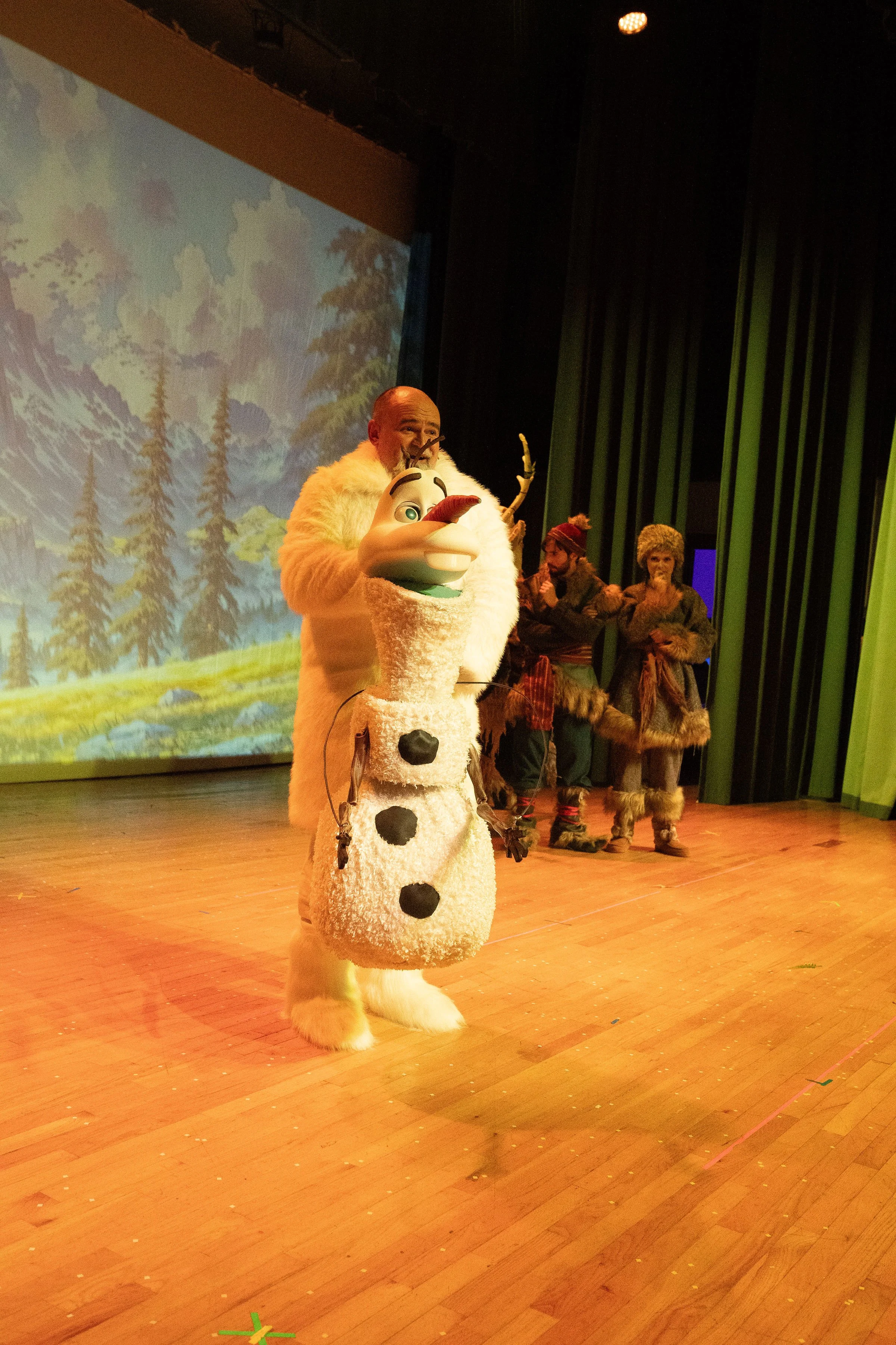Olaf puppet on stage with other performers