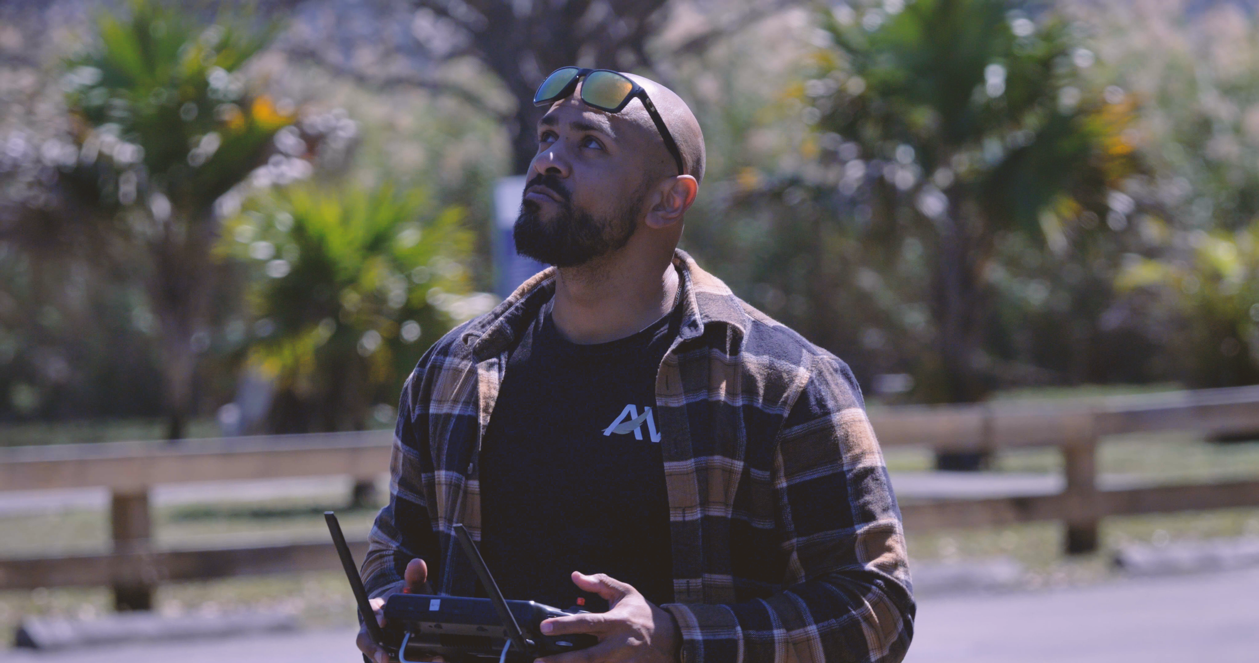 Kevin Padilla, founder of Aerovis drone solutions, operating a drone during a field mission wearing Aerovis branded gear.
