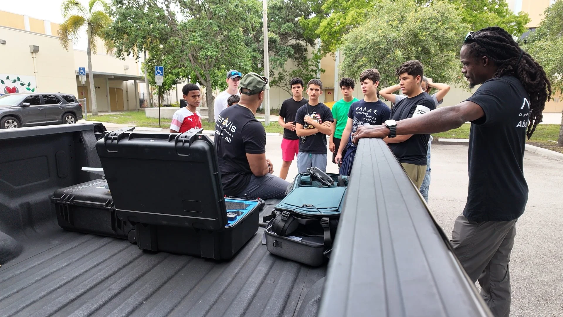 Kevin Padilla teaching Western High JROTC cadets drone operations from a truck tailgate