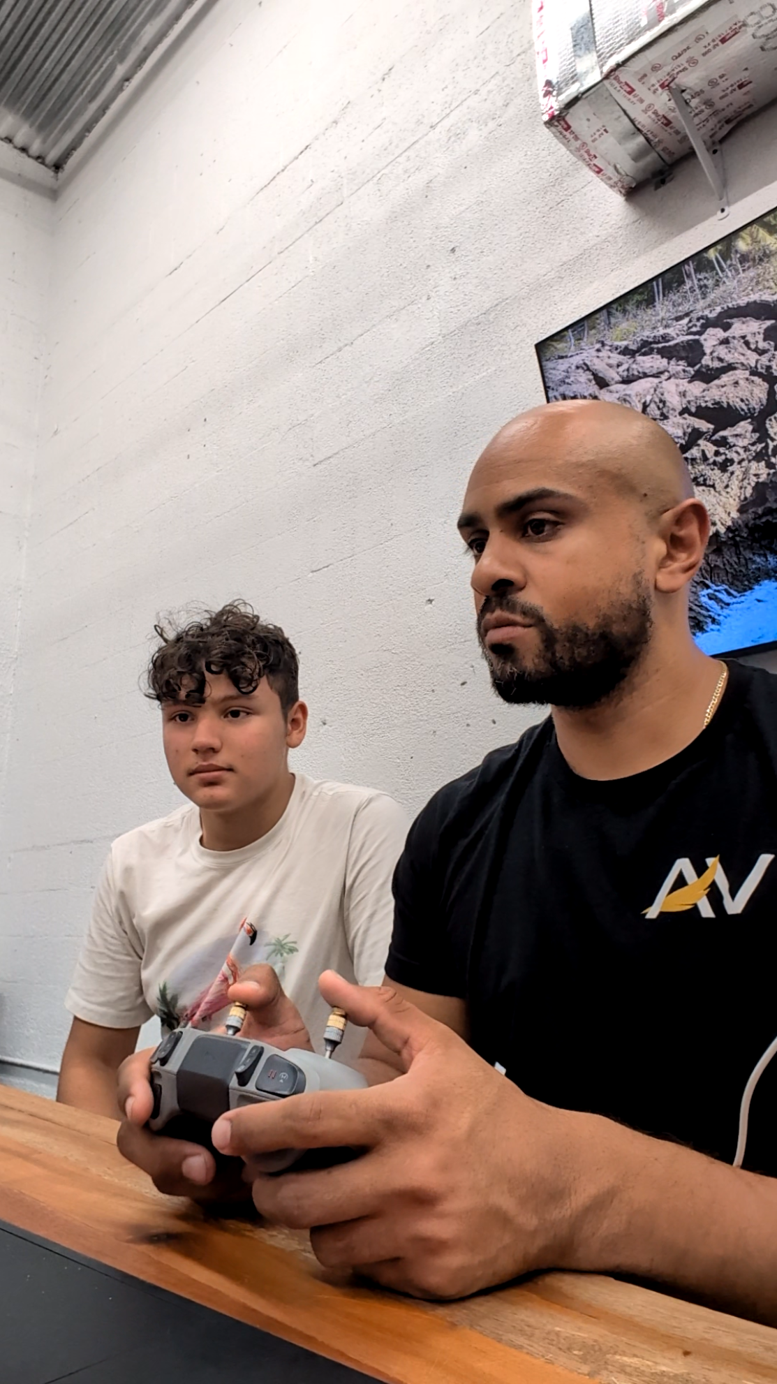 AeroVis founder Kevin Padilla mentoring an intern on drone controller operations at company headquarters