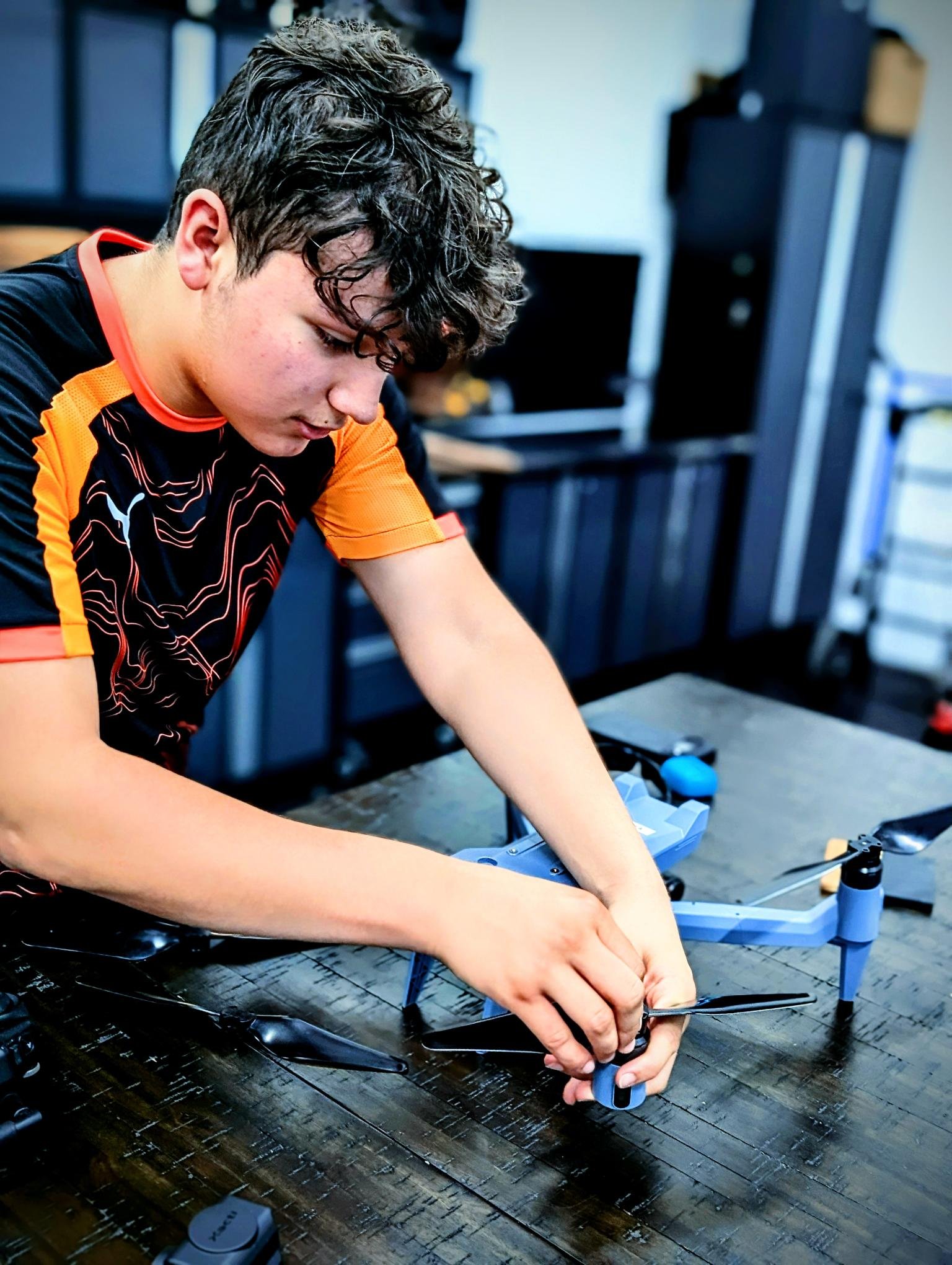 AeroVis intern performing hands-on drone maintenance and assembly during the commercial drone internship program in South Florida
