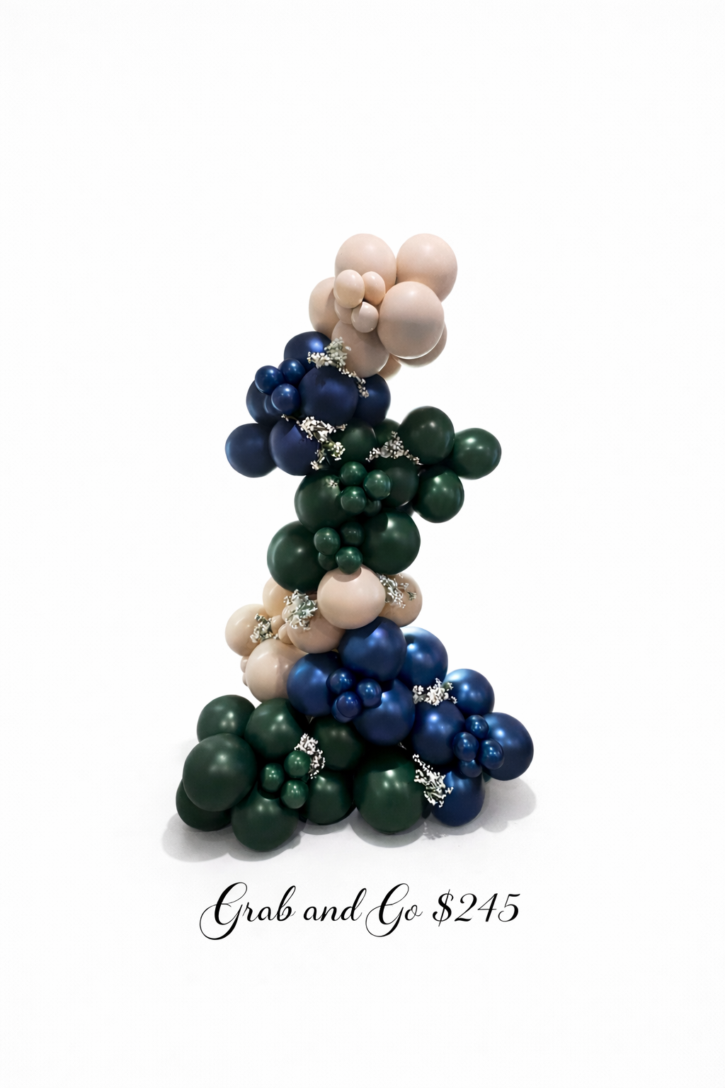 A balloon free standing garland made of green, blue, beige, and dark blue balloons, decorated with small white floral accents, with the text 'Grab and Go $245' at the bottom.