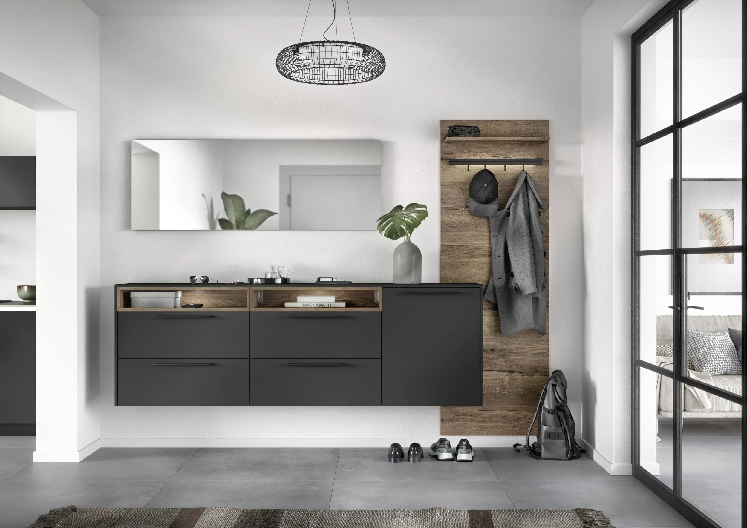 Hall med svarta skåp, en stor växt i vas, spegel på väggen, hatthängare med kläder och hatt, skor och ryggsäck på golvet, glasdörr till vardagsrum, modern inredning.