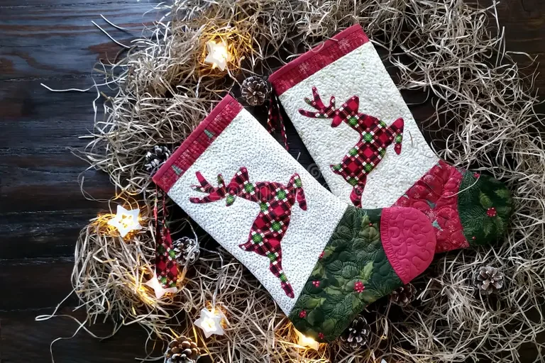 traditional-patchwork-quilt-christmas-background-quilting-socks-hand-made-dark-wood-deers-lights-cones-paper-shavings-259885916.webp