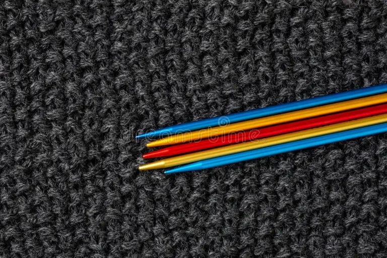 set-colored-knitting-needles-set-colored-knitting-needles-knitted-product-as-background-261506544.webp