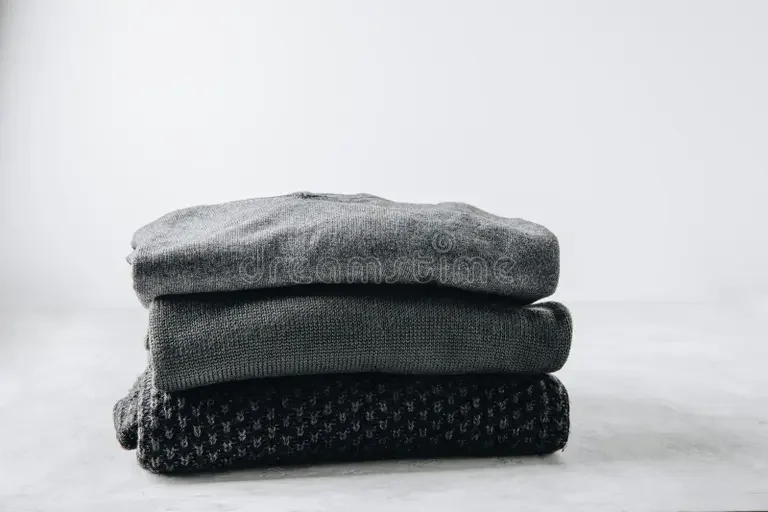 sweaters-black-knitted-gray-background-stacked-269957480.webp
