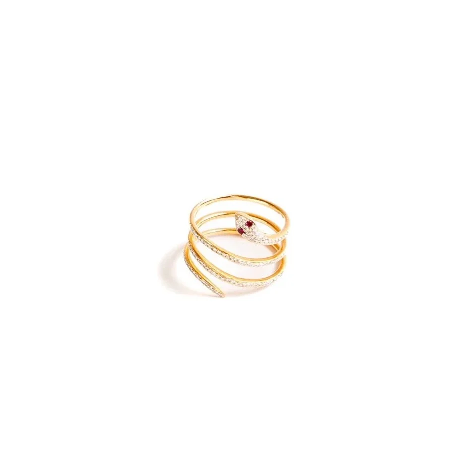 18k rose gold coiled snake ring with diamond pavé and ruby eyes, photographed upright on a white background.