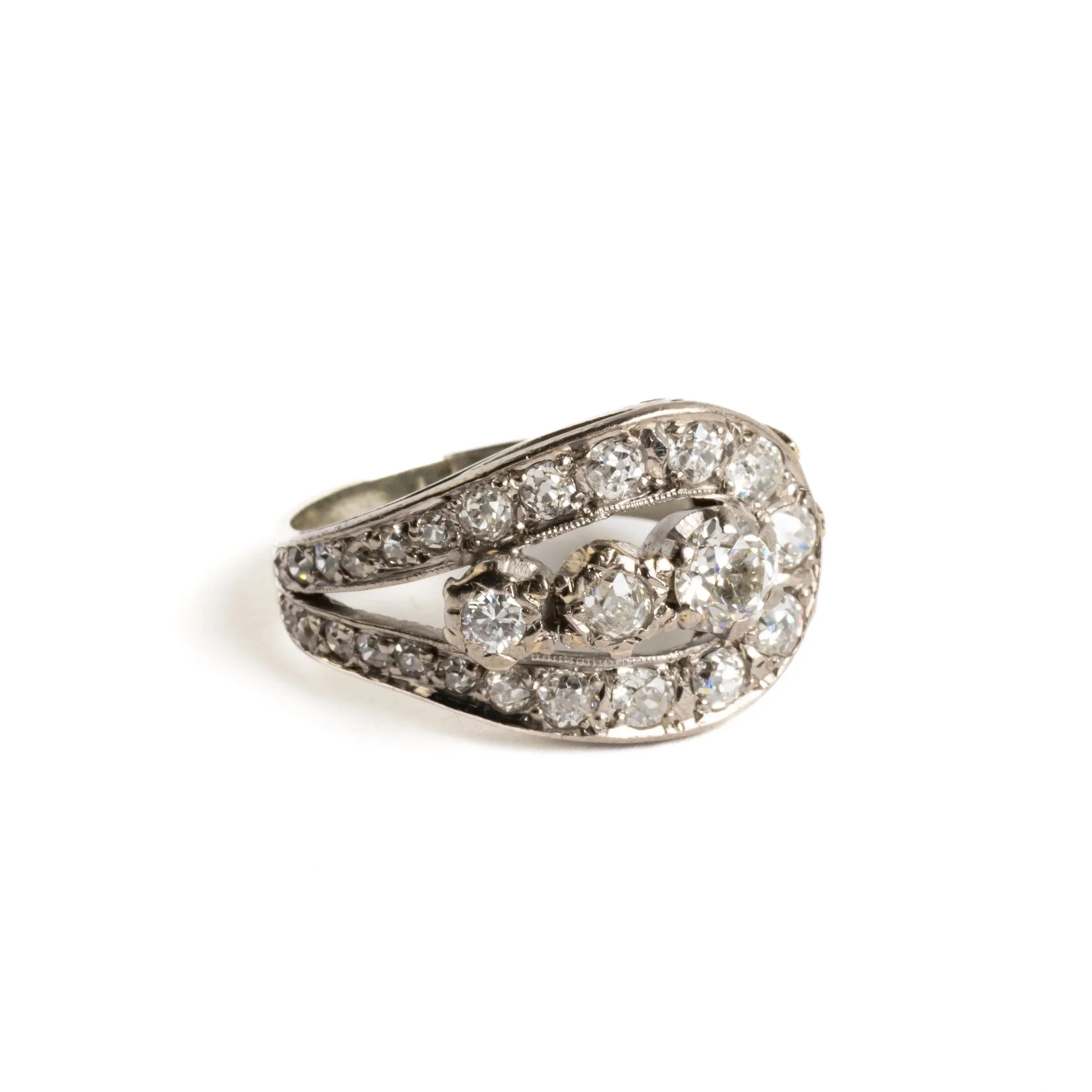 Vintage 18ct white gold diamond cluster ring with approx. 1.9ct of brilliant and transitional-cut diamonds in a curved Art Deco–influenced design, photographed on a light background.