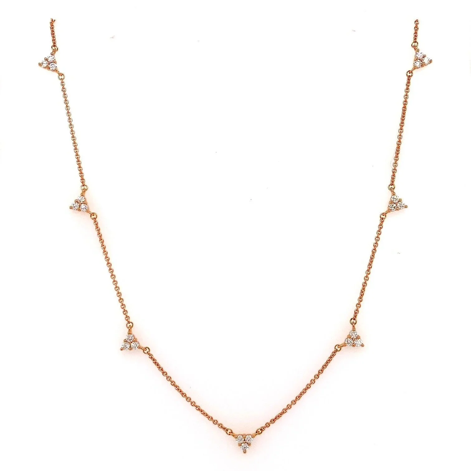 Tatiana diamond necklace in 9ct gold featuring seven delicate trio-cluster stations on an adjustable Italian chain, displayed against a soft neutral backdrop.