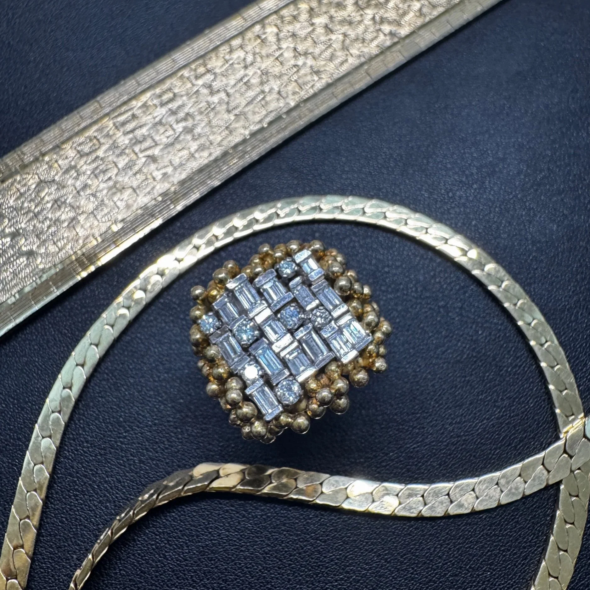 Vintage gold diamond statement ring styled with vintage herringbone necklaces