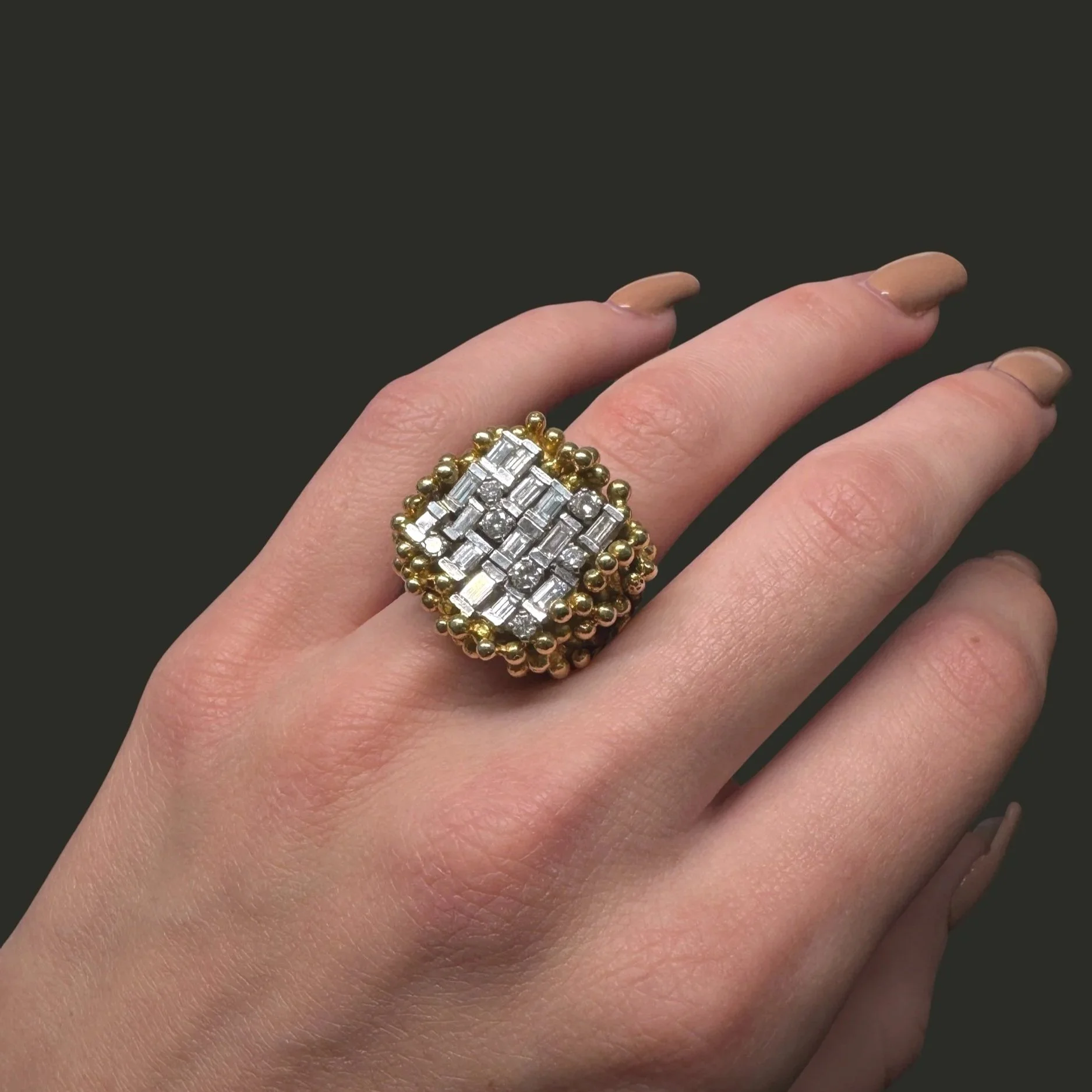 Vintage 18K gold brutalist diamond ring worn on hand with baguette and brilliant cut diamonds