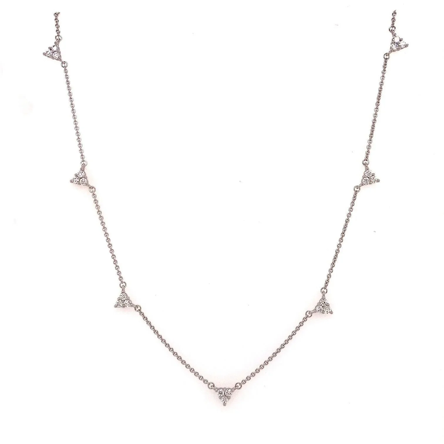 Tatiana diamond necklace in 9ct gold featuring seven delicate trio-cluster stations on an adjustable Italian chain, displayed against a soft neutral backdrop.