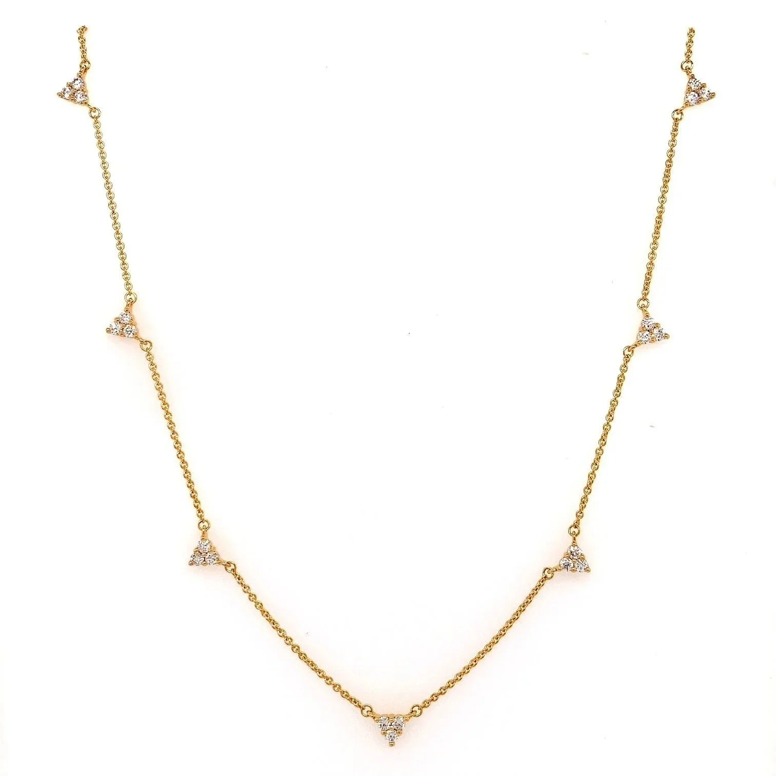 Tatiana diamond necklace in 9ct gold featuring seven delicate trio-cluster stations on an adjustable Italian chain, displayed against a soft neutral backdrop.