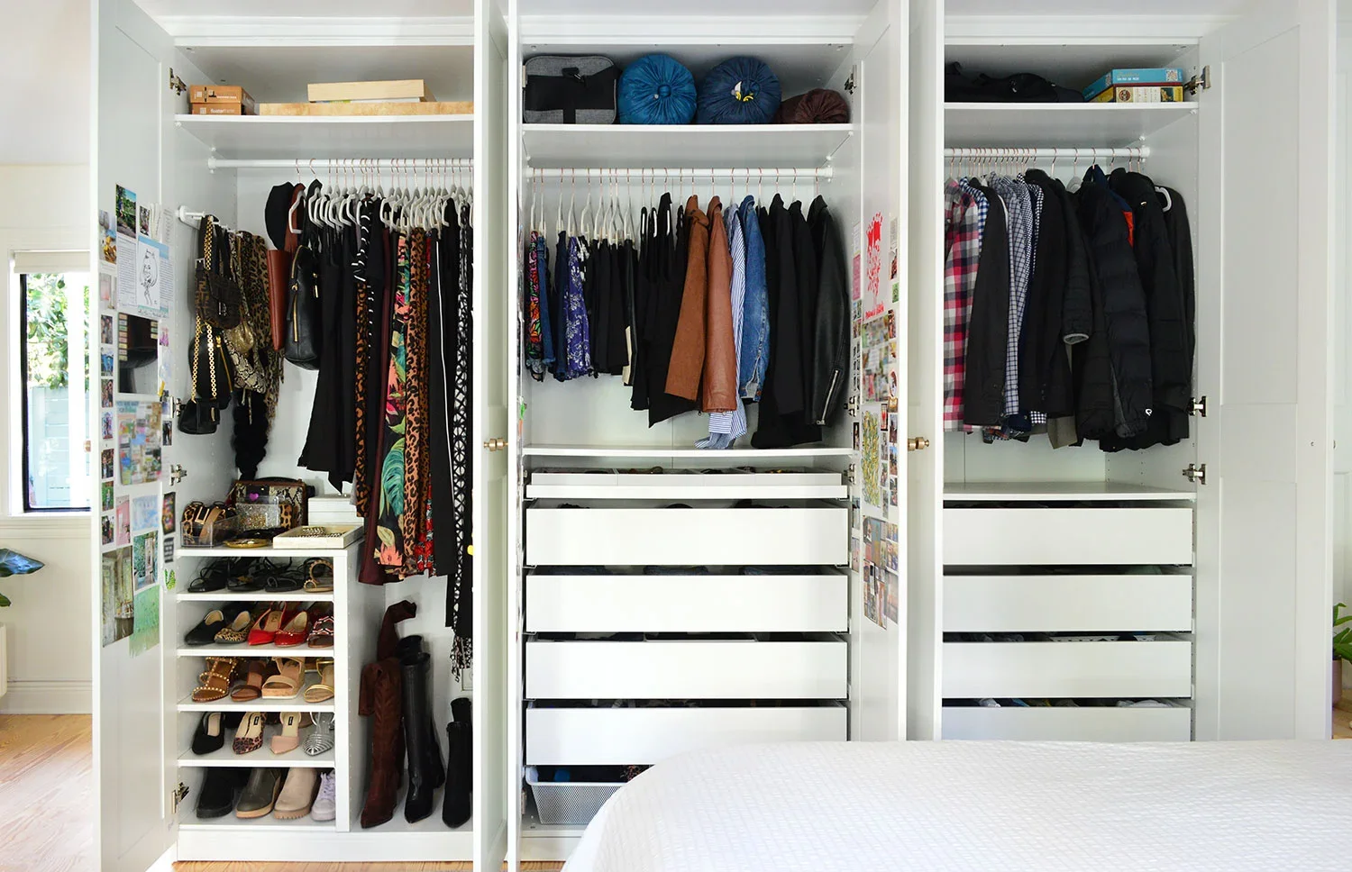 Open walk-in closet with hanging clothes, shoes, handbags, and storage drawers.