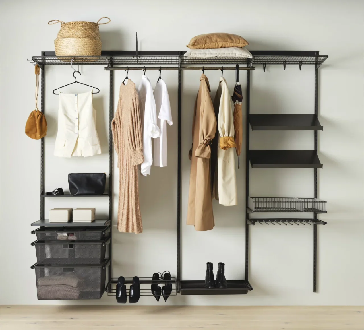 Wall-mounted clothing storage with various clothing items, shoes, hats, and accessories.