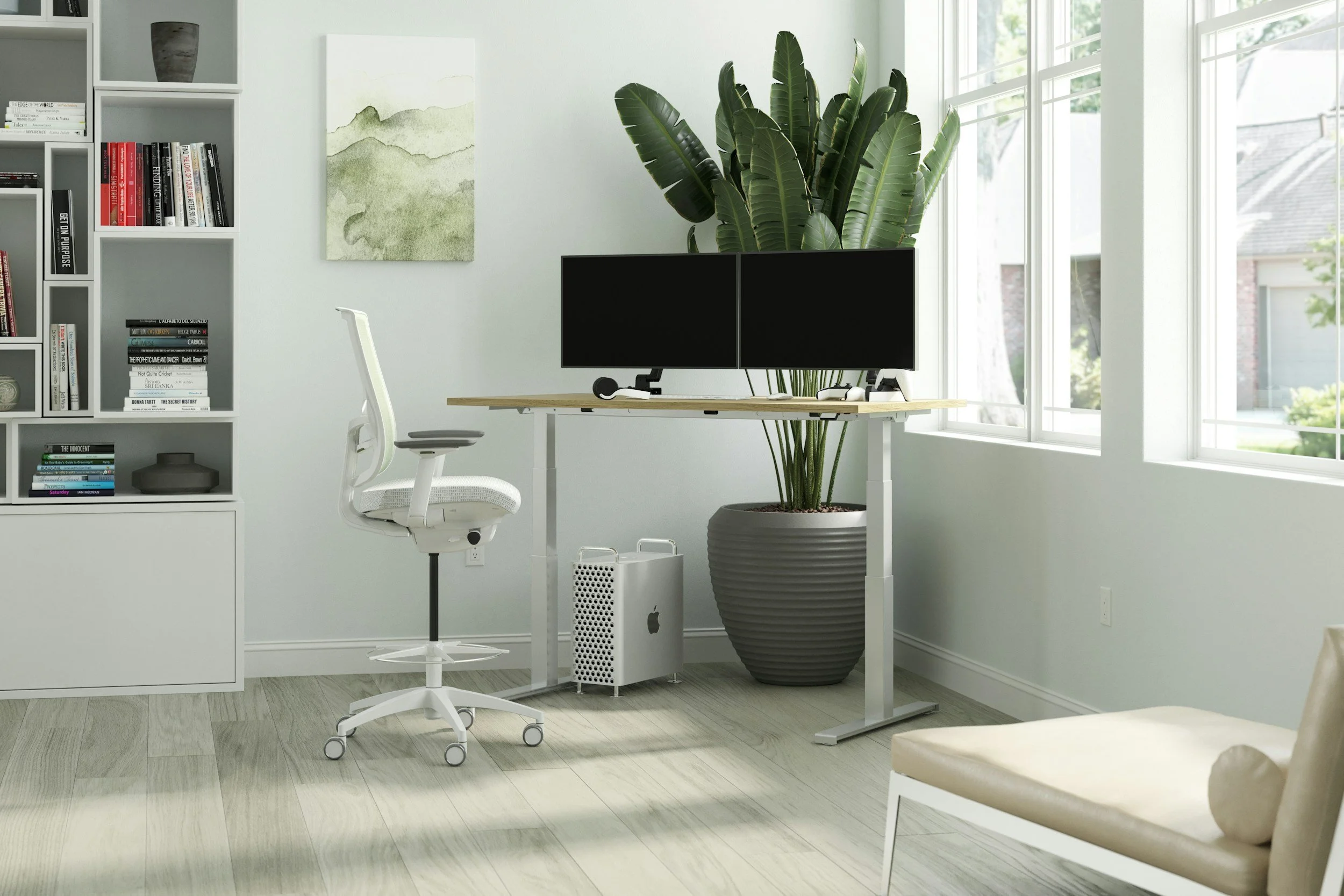 Modern home office with a white desk holding dual monitors, a white ergonomic chair, a large potted green plant, and a white bookshelf filled with books and decorative items, set near a window with natural light.