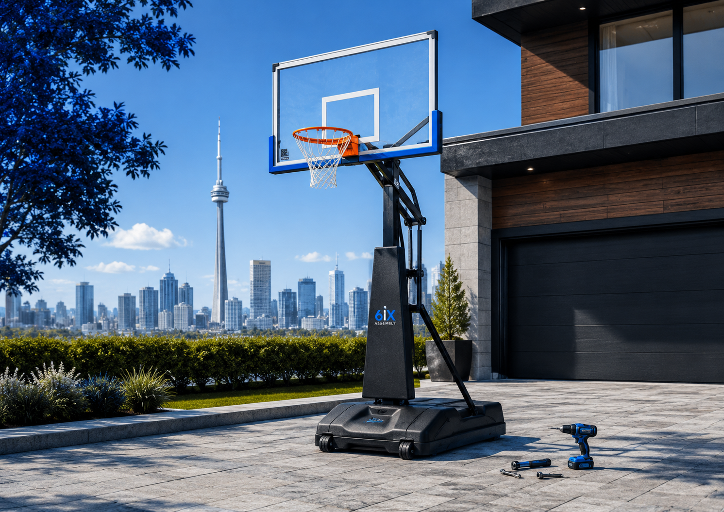 Portable basketball hoop professionally assembled in a Toronto driveway with tools nearby and the city skyline in the background.