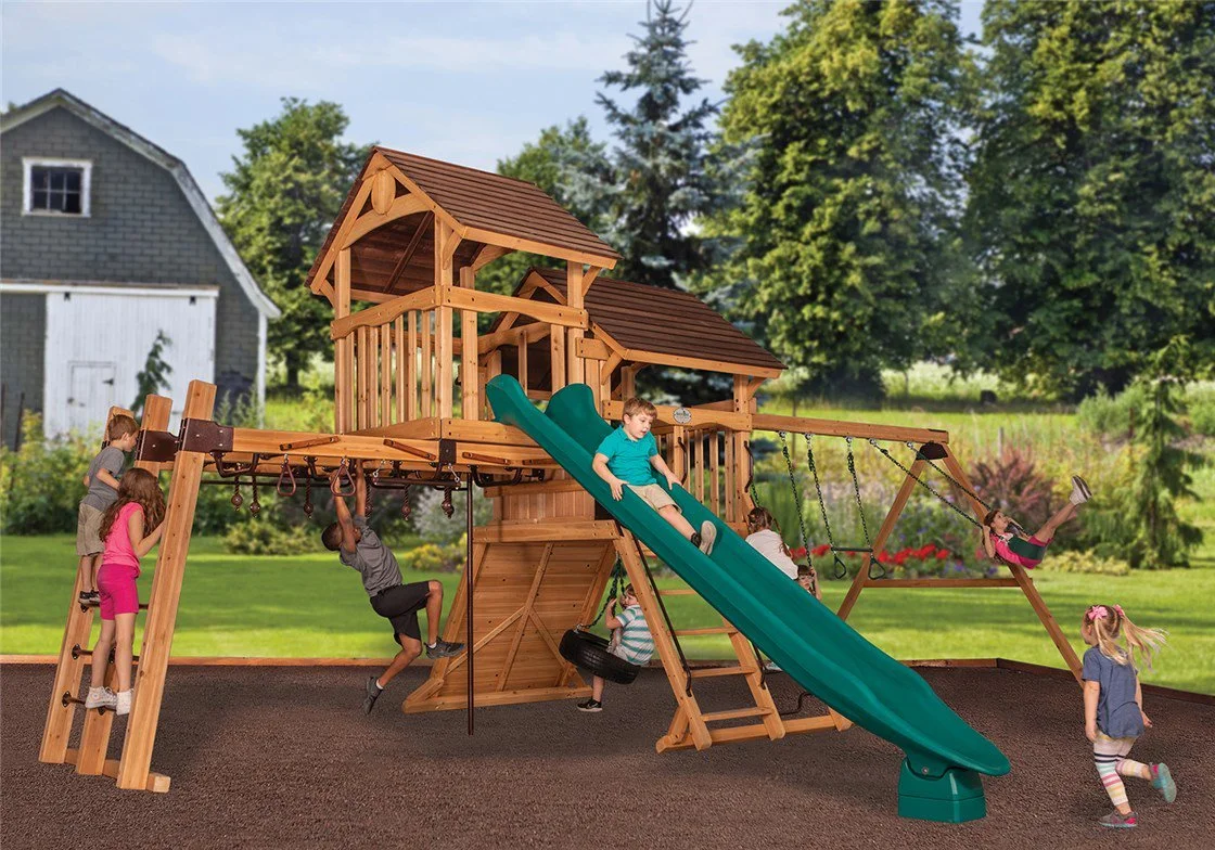 Children playing on a large wooden outdoor playground with slides, swings, and climbing areas in a backyard with trees and a gray house in the background.