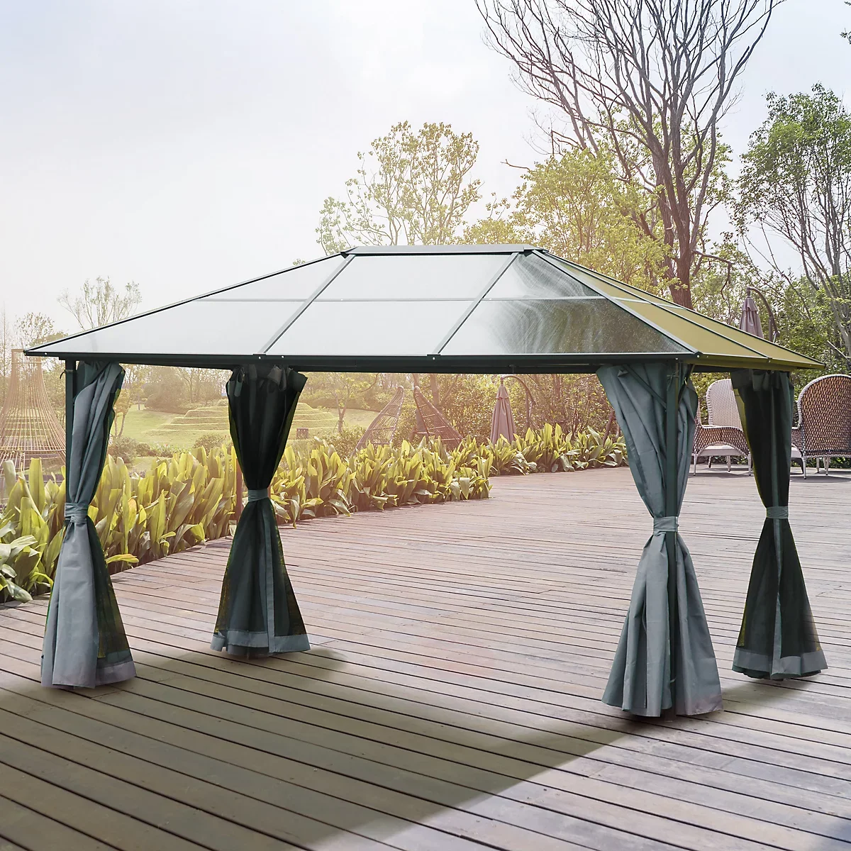 A gazebo with black curtains and a glass roof on a wooden deck in a garden.